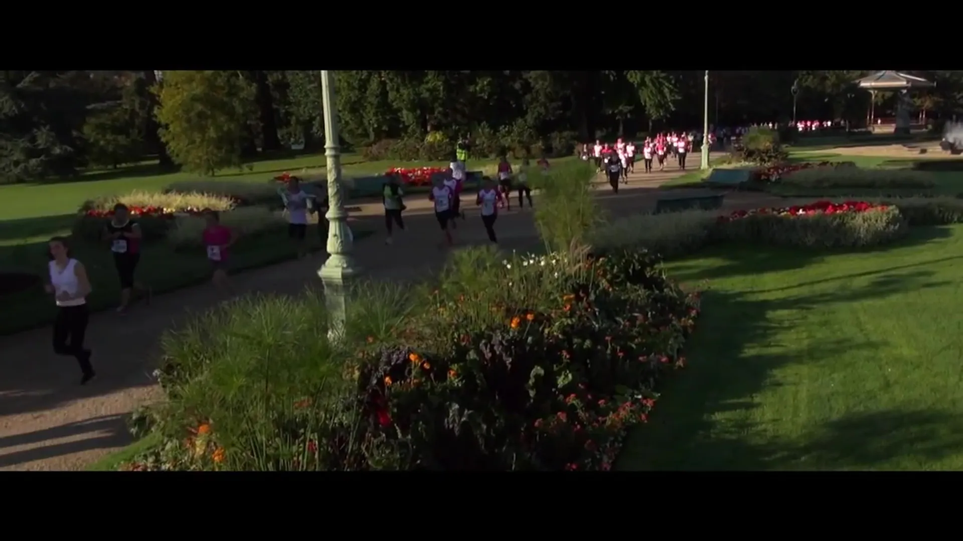 The image shows a group of people participating in what appears to be a running or