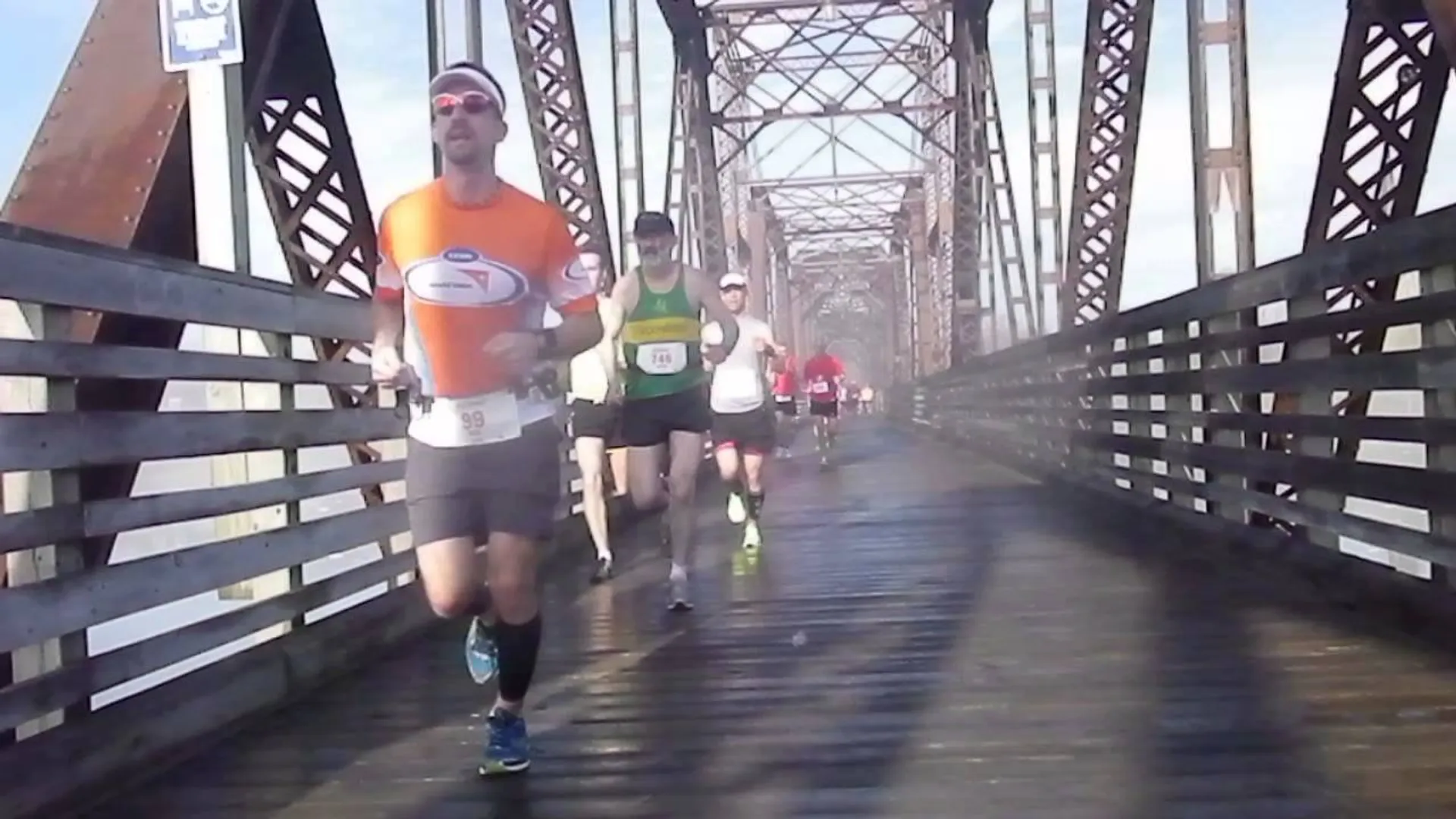 The image depicts a group of people engaged in a running event, likely a race