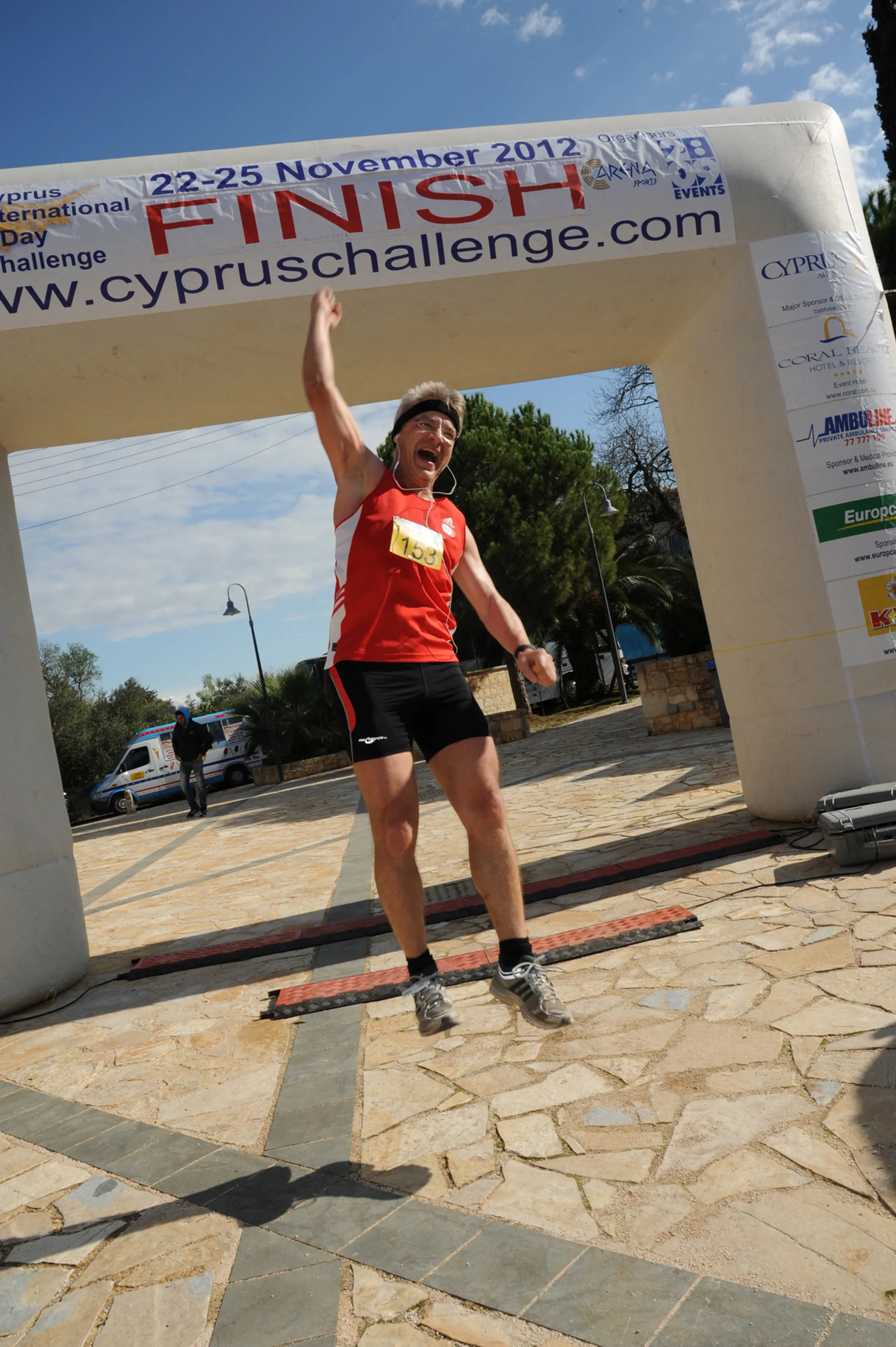The image shows a person who appears to be jubilant as they are crossing