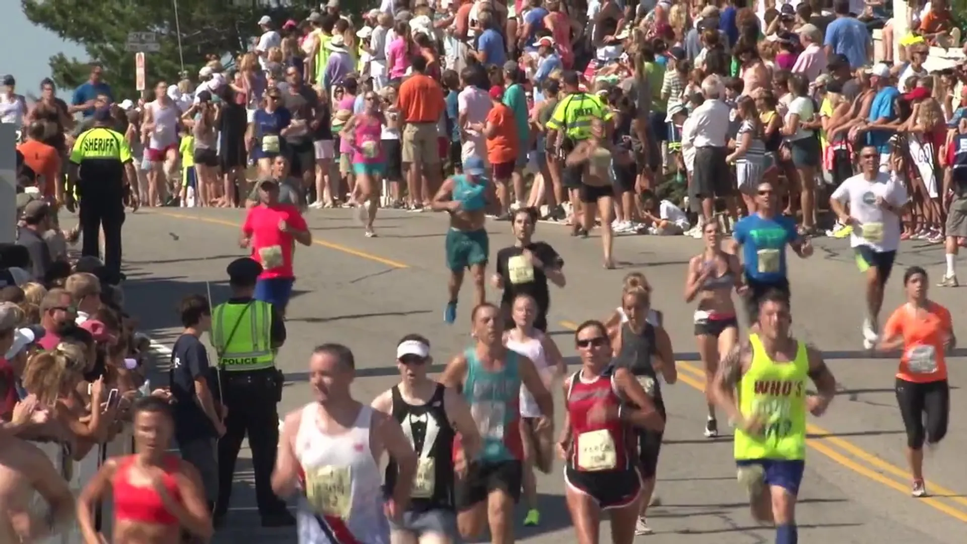 The image shows a crowd of people participating in a running event. It appears to
