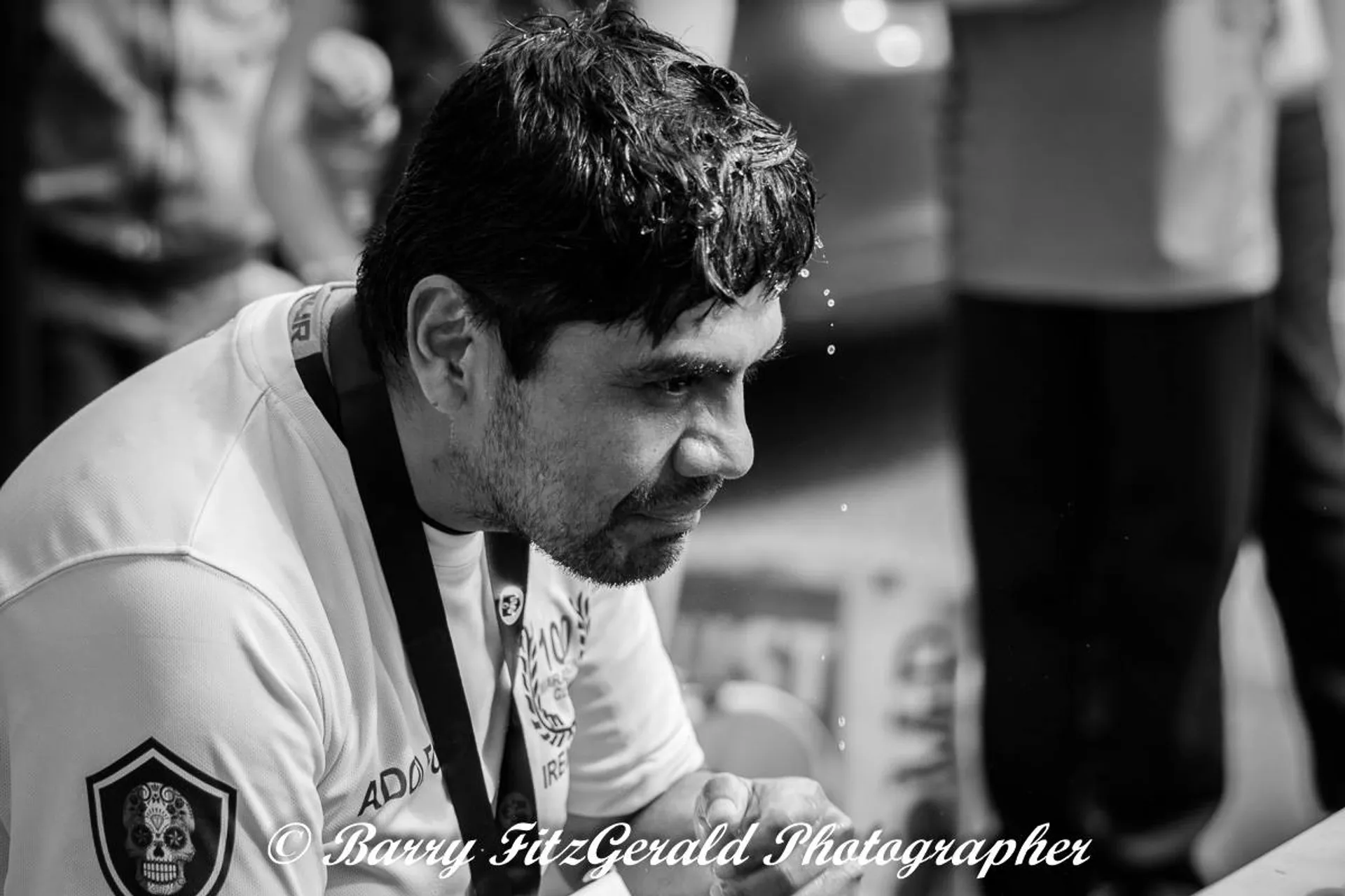 The image shows a black-and-white photograph of a person who appears to be tired