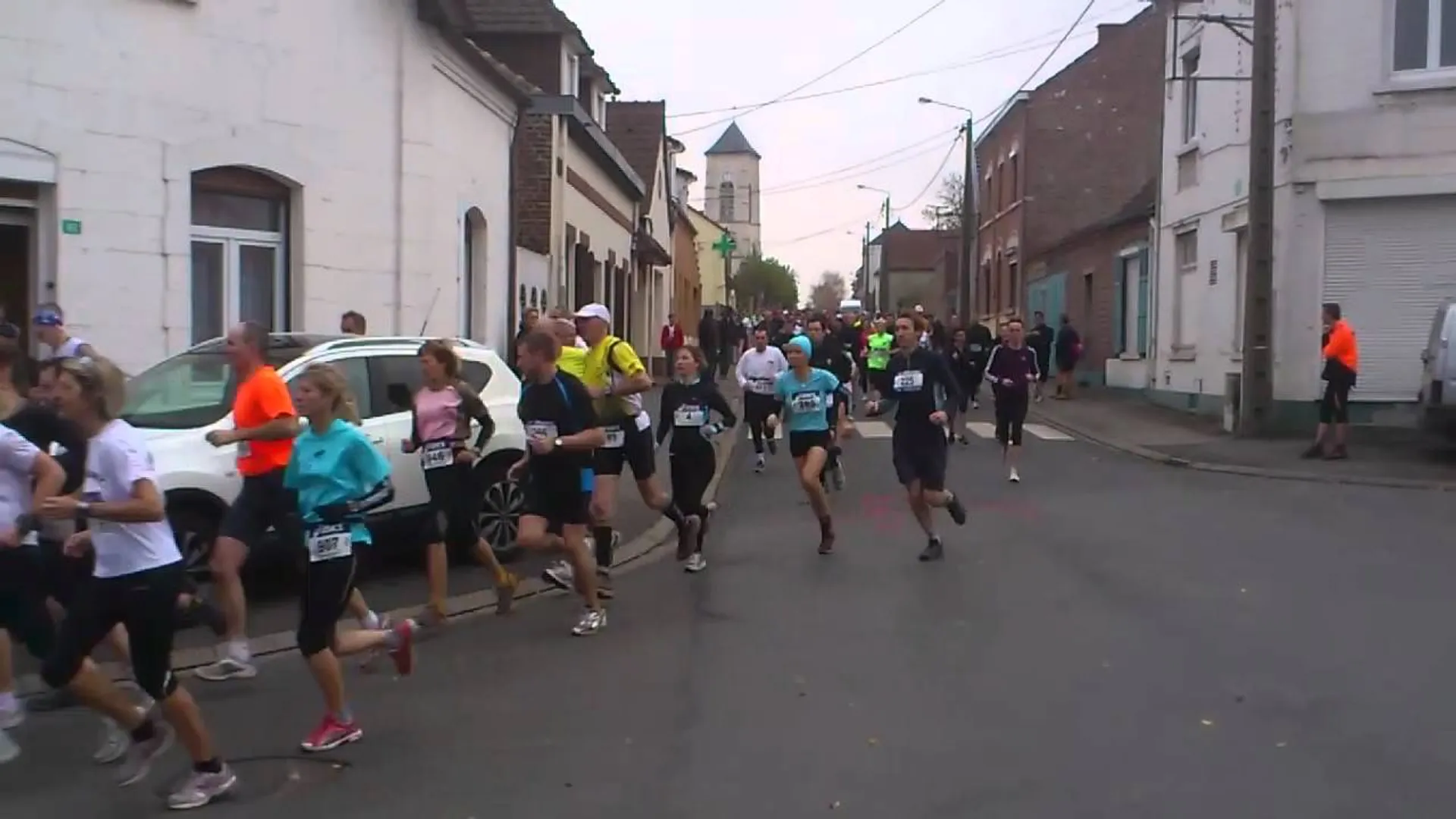 The image shows a group of people participating in a running event, possibly a race