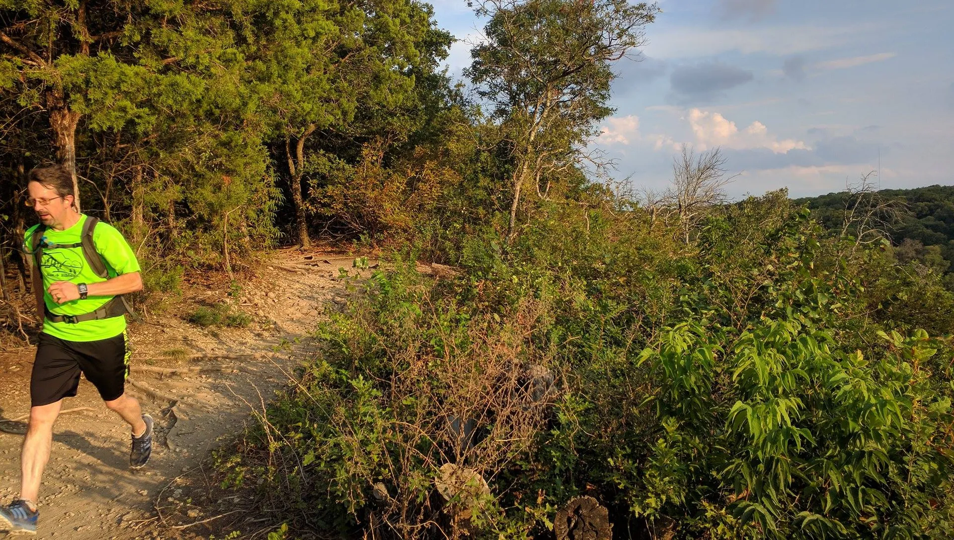 In this image, there is an individual, likely a man, jogging along a