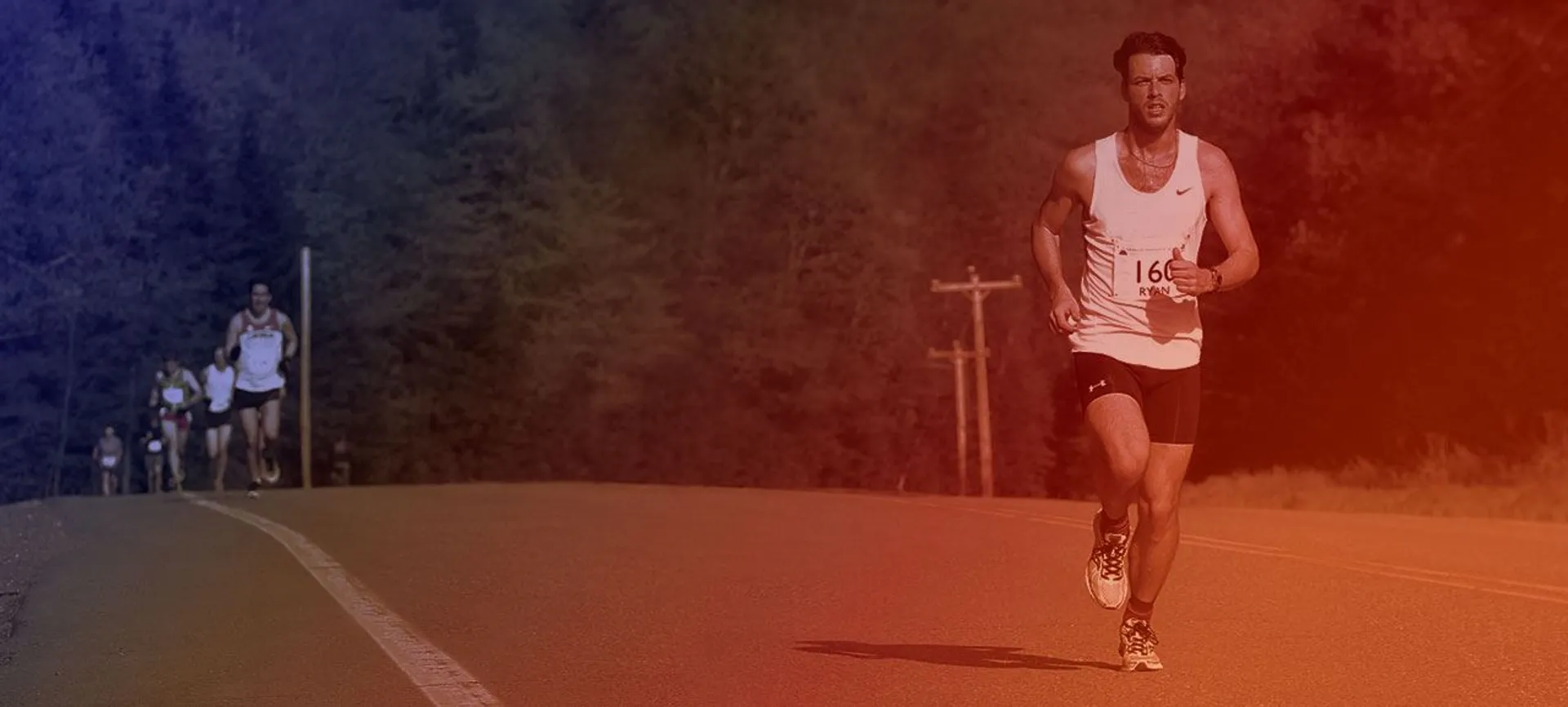 The image shows a group of runners participating in a road race. One runner,