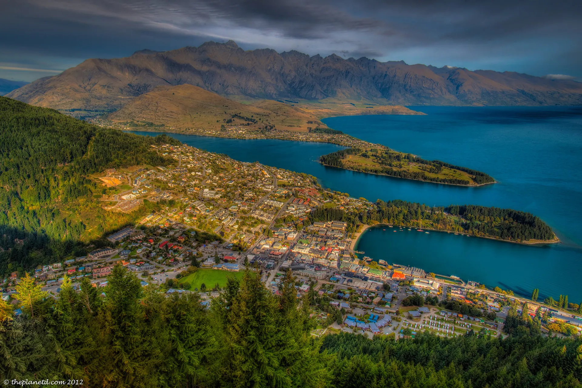 This image showcases a breathtaking view of a lakeside town situated at the foot of