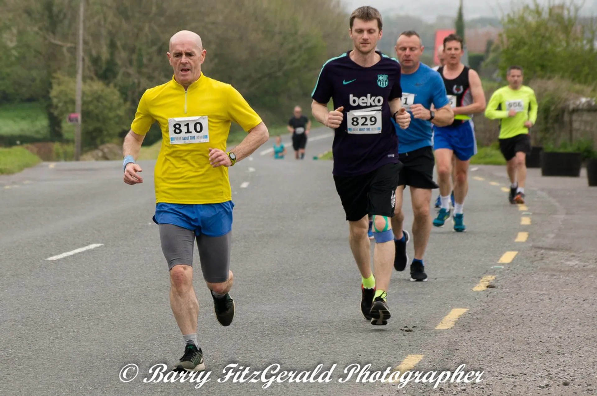 The image shows a group of people participating in a running event, likely a race