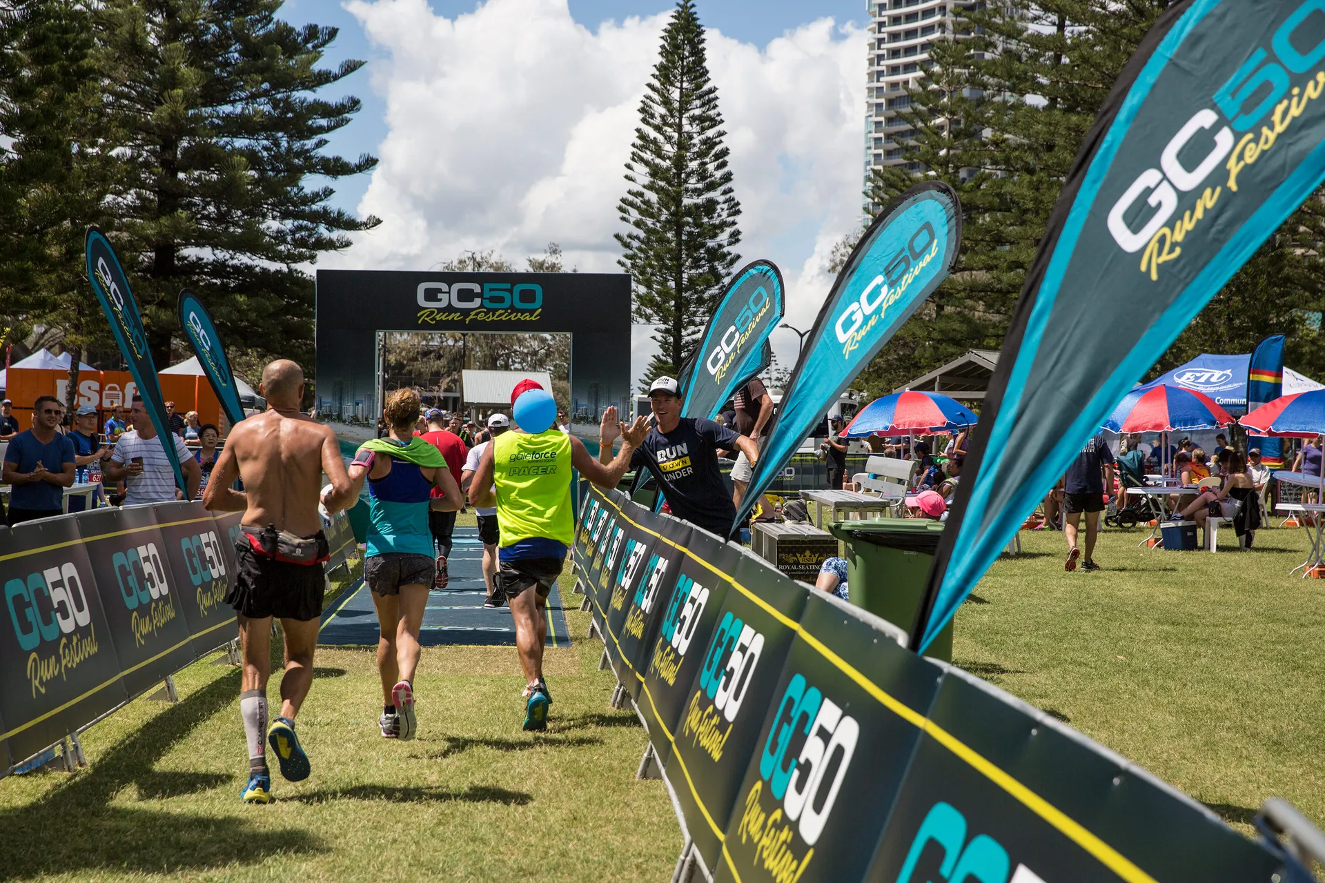 The image depicts a running event, possibly a race or a marathon, where participants