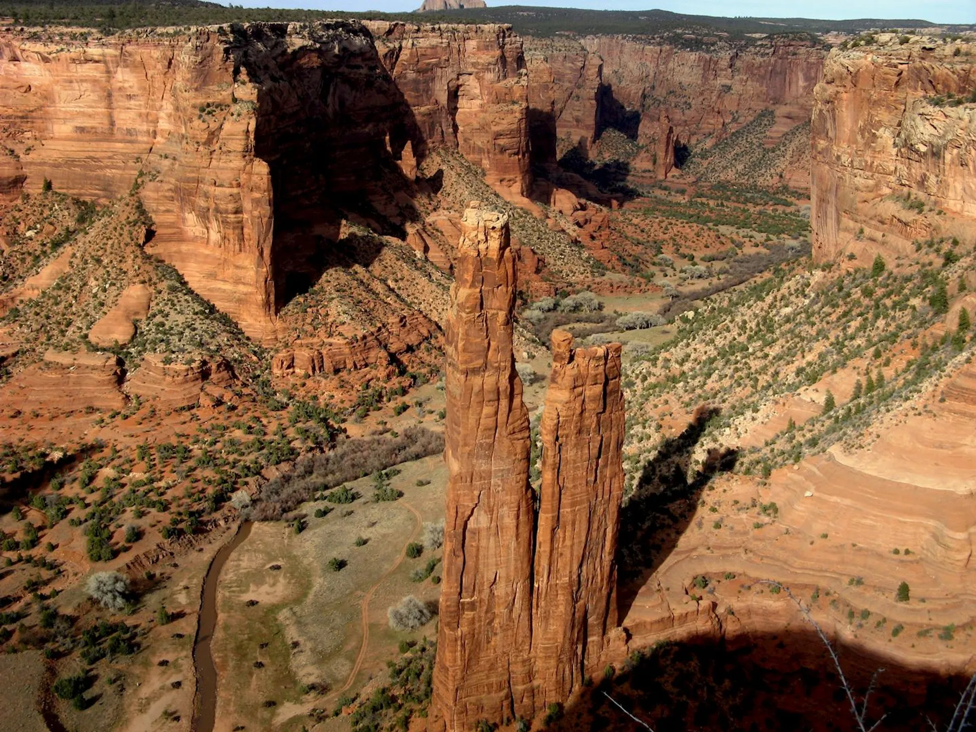 This image features a breathtaking view of a red rock canyon. The canyon has steep