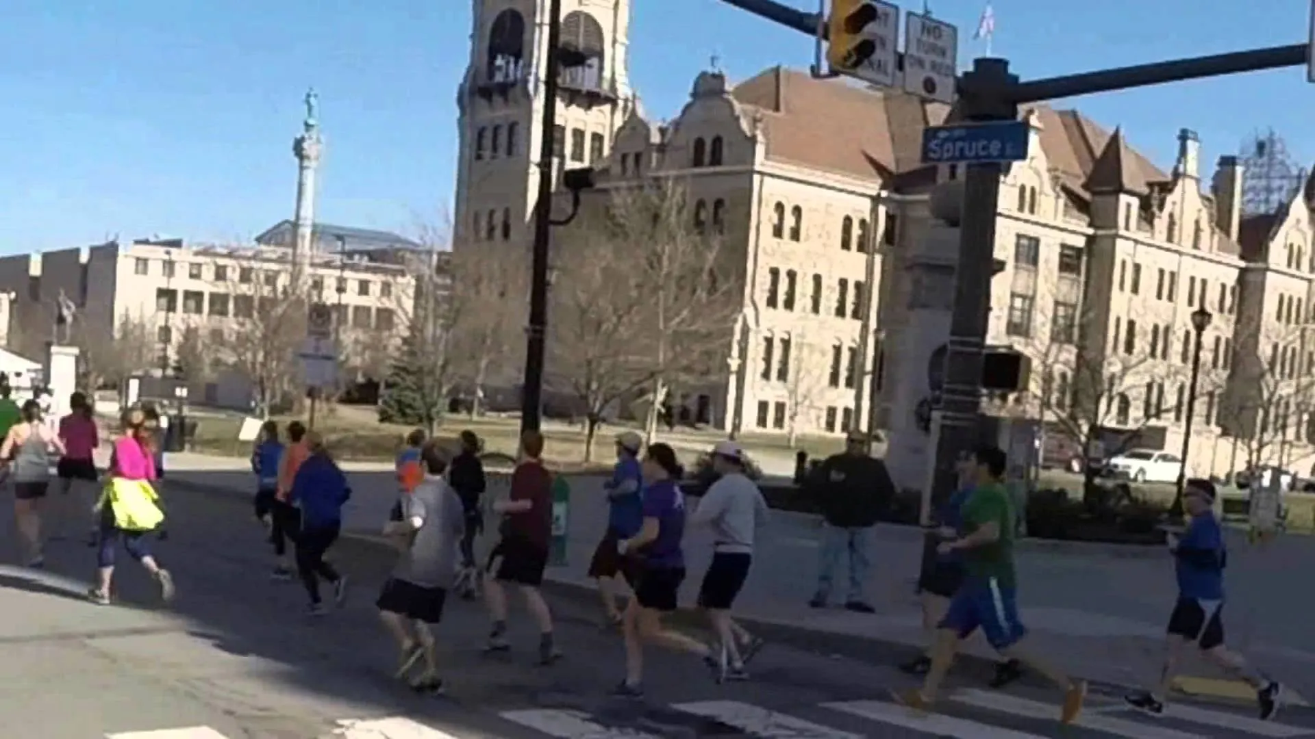 The image depicts a group of people engaged in running, possibly part of a race