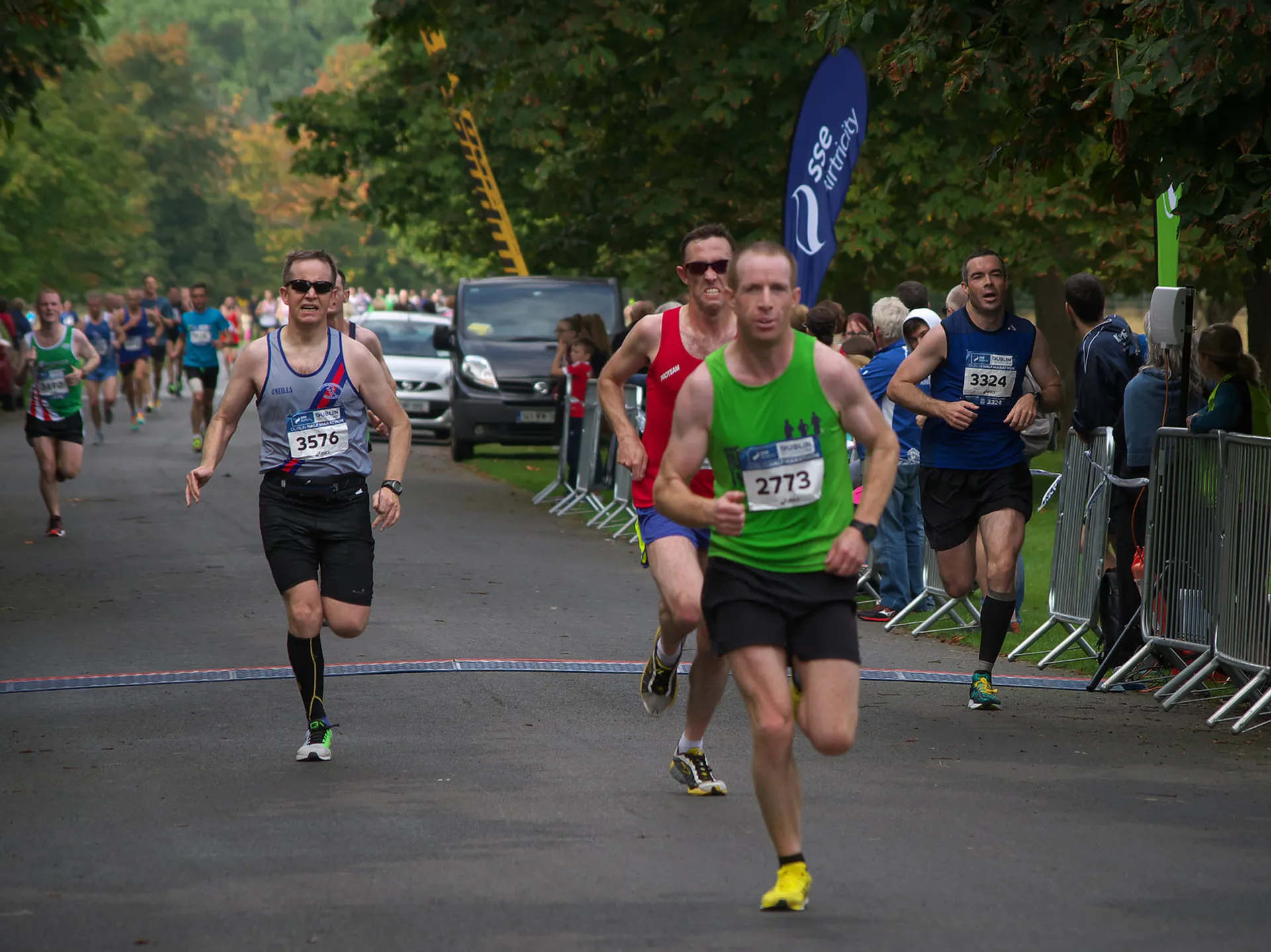 The image shows a group of runners participating in a race. They're on a