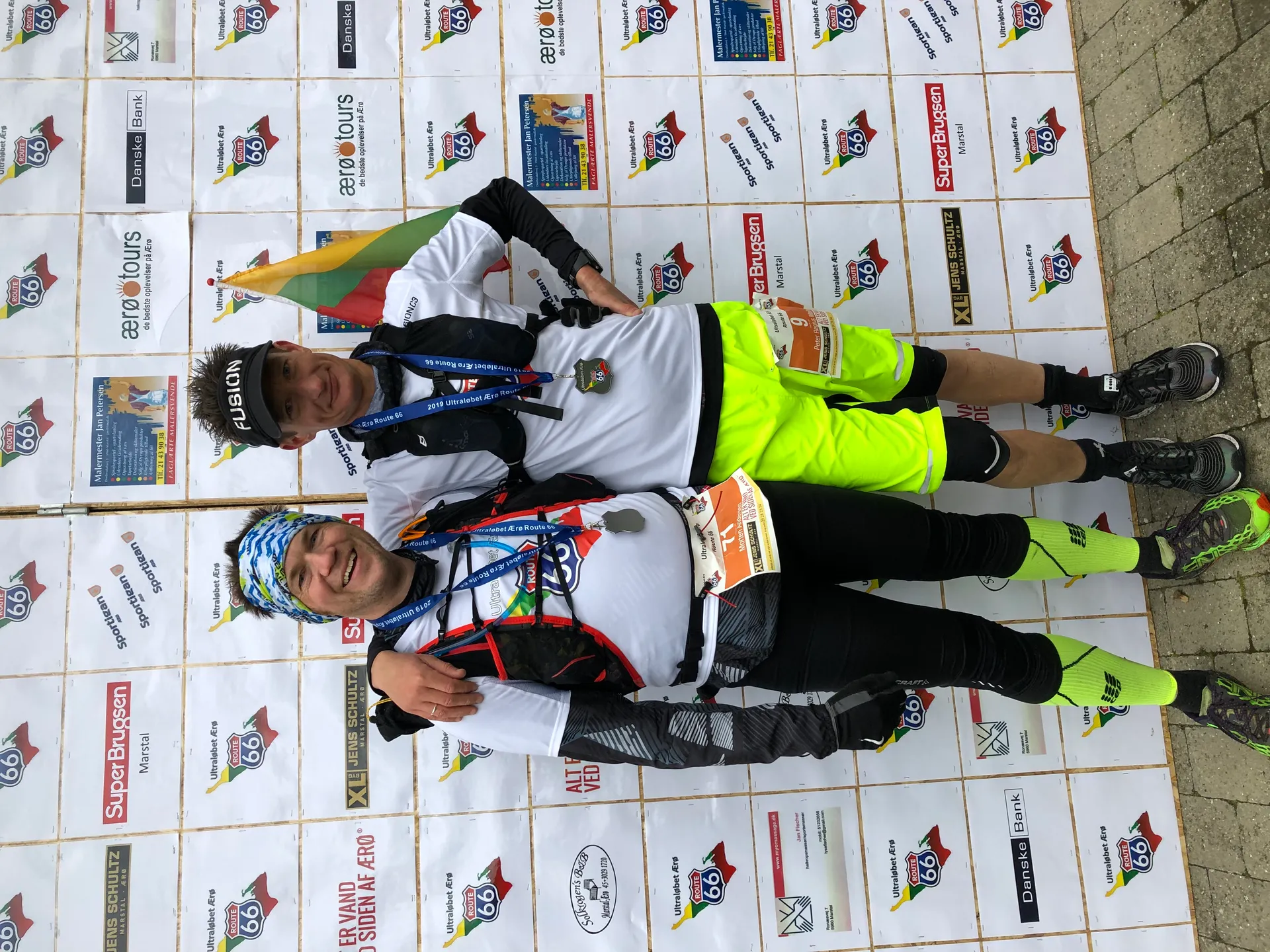 The image shows two people wearing athletic attire, with one arm around each other,