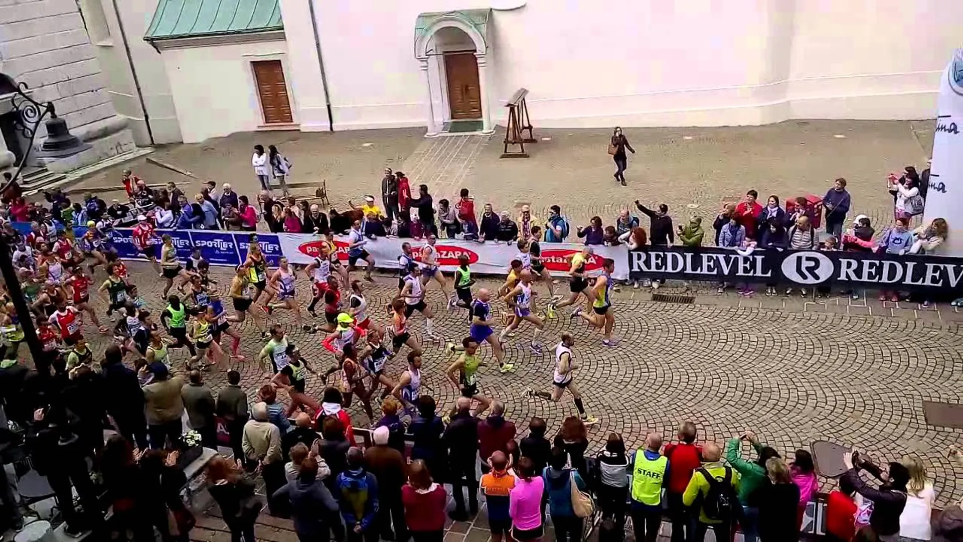 The image depicts a running event, likely a marathon or a race, where a