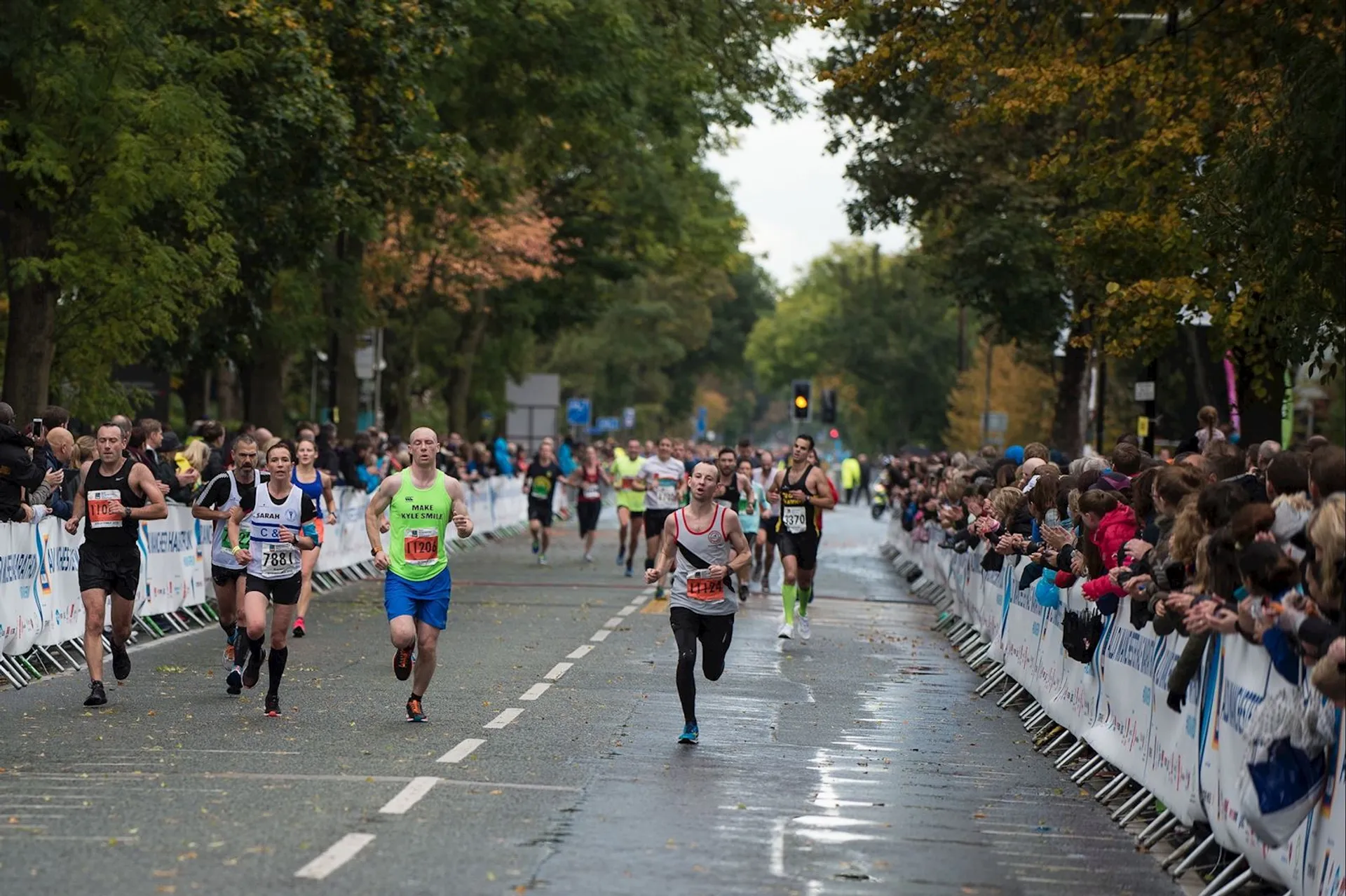 This image shows a group of runners participating in a road race, likely a marathon