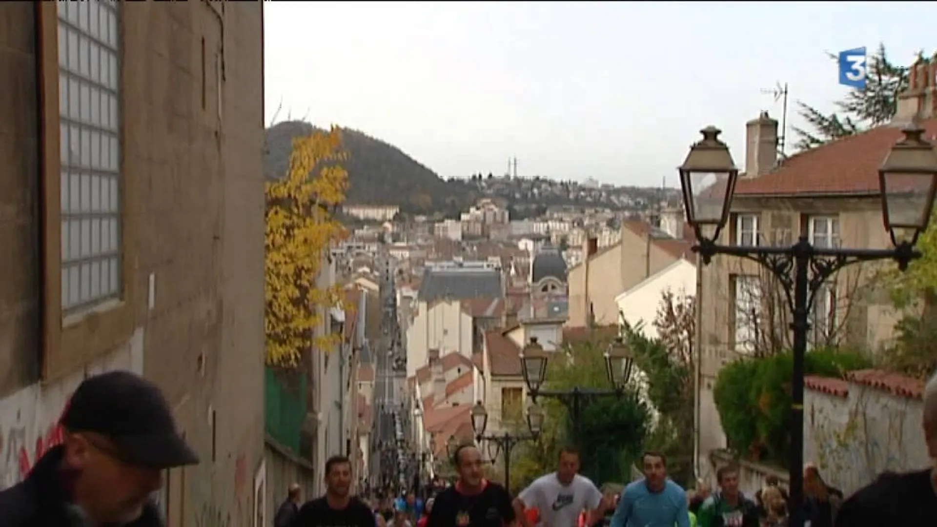 The image shows a street scene with people, likely taken from an elevated position looking
