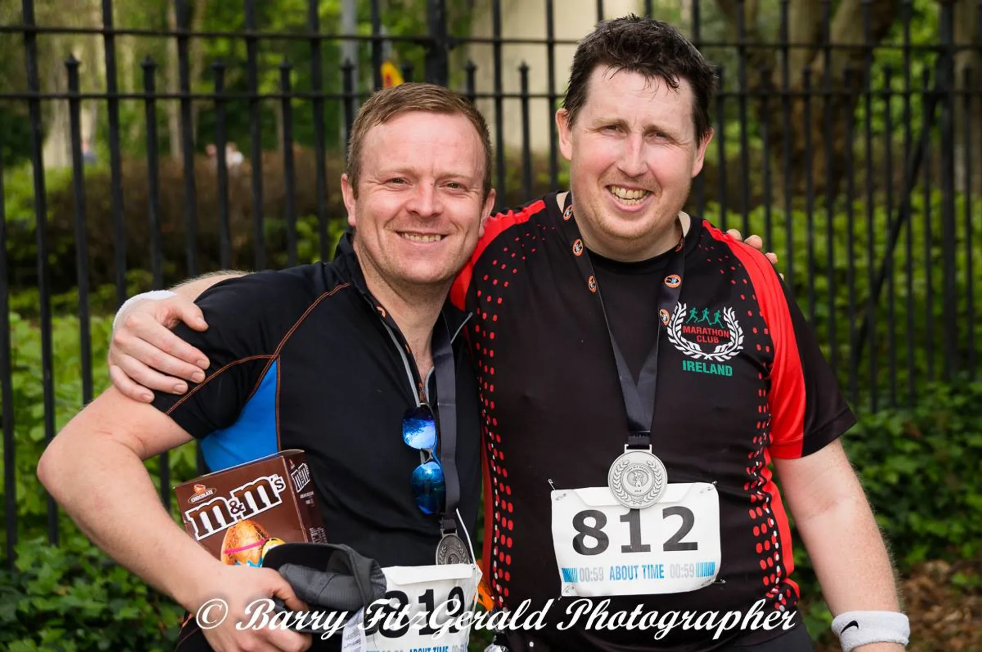 This image shows two individuals posing for a photograph after what appears to be a running