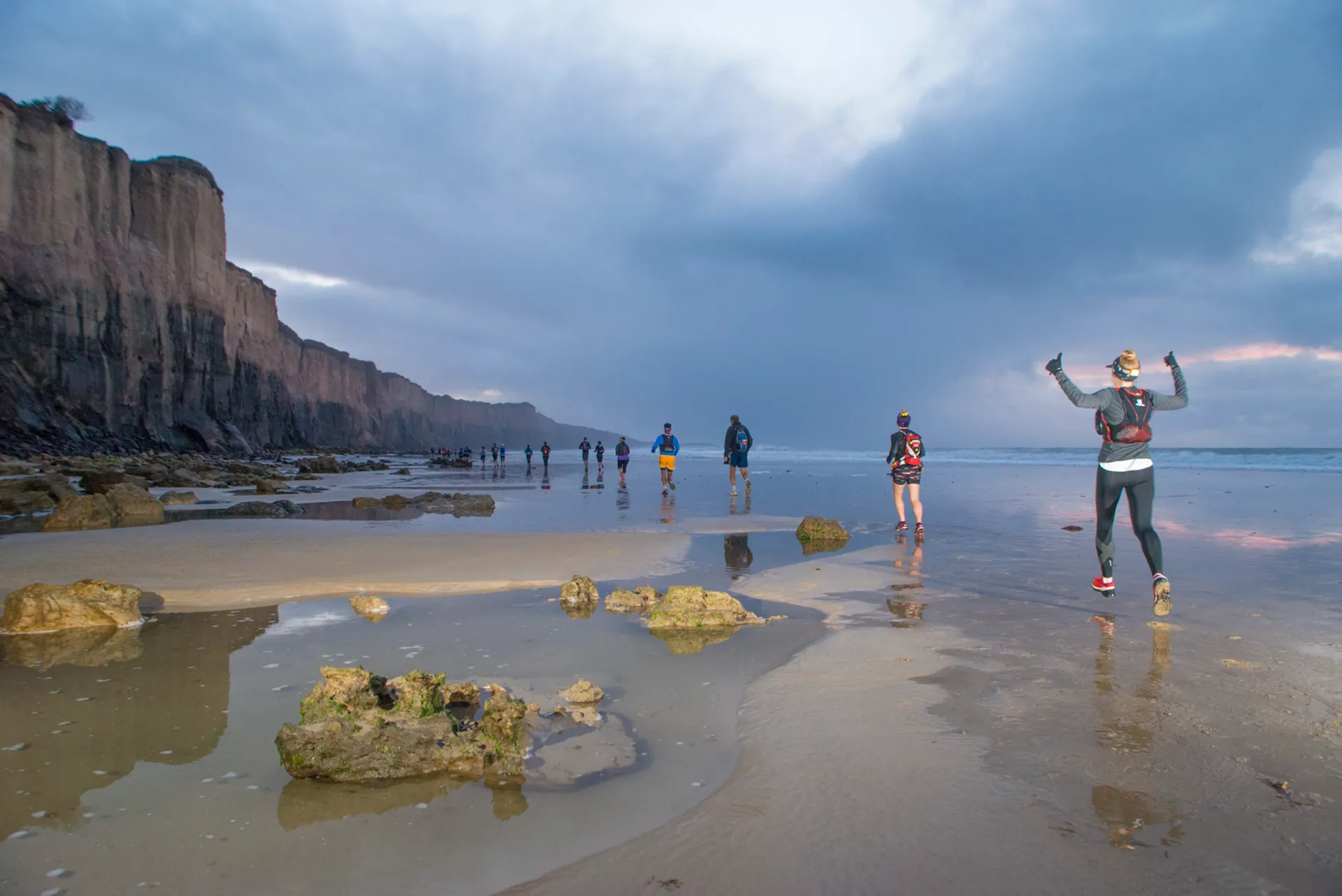 The image features a scenic beach at what appears to be either dawn or dusk,