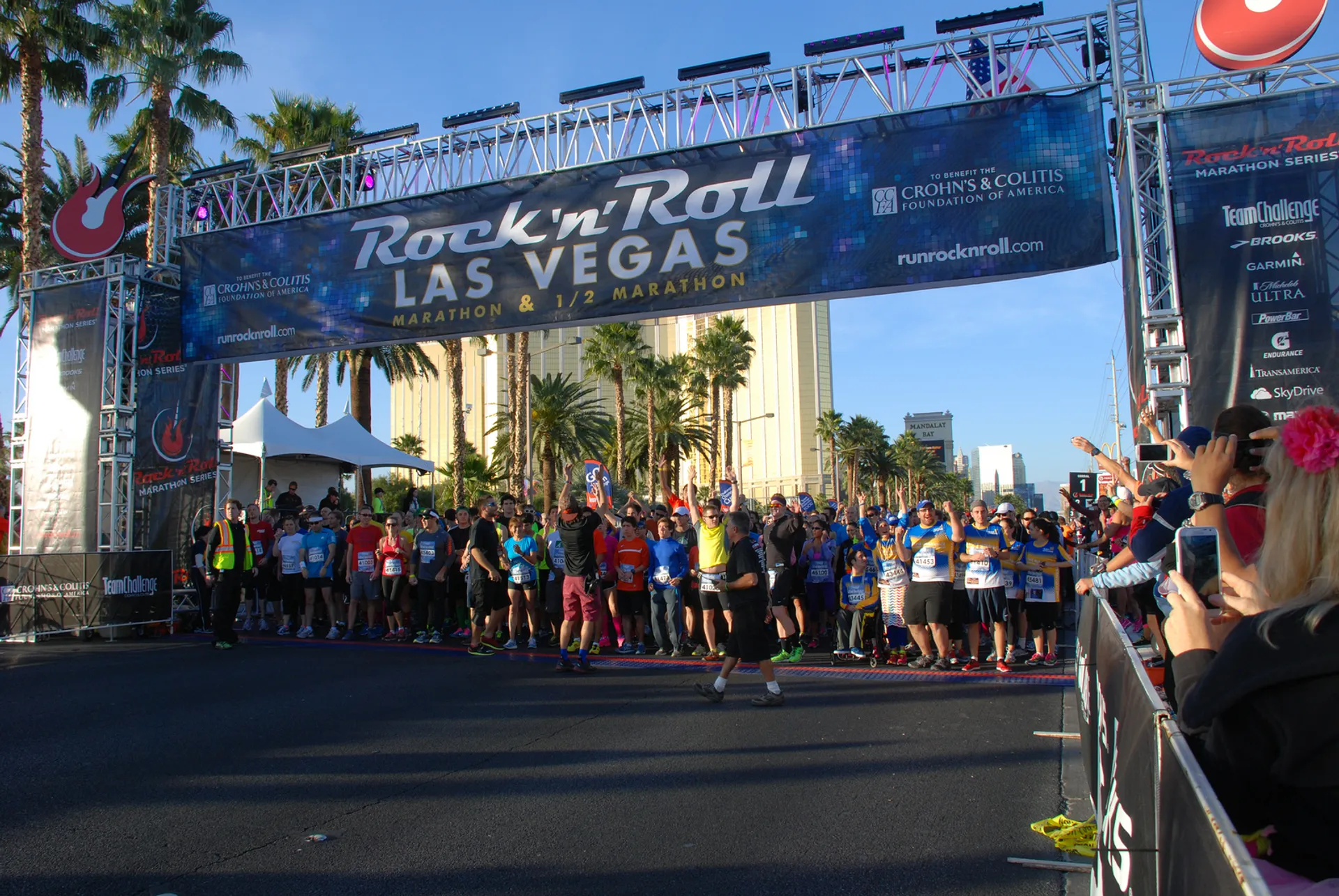 In this image, there is a group of runners lined up at the starting line