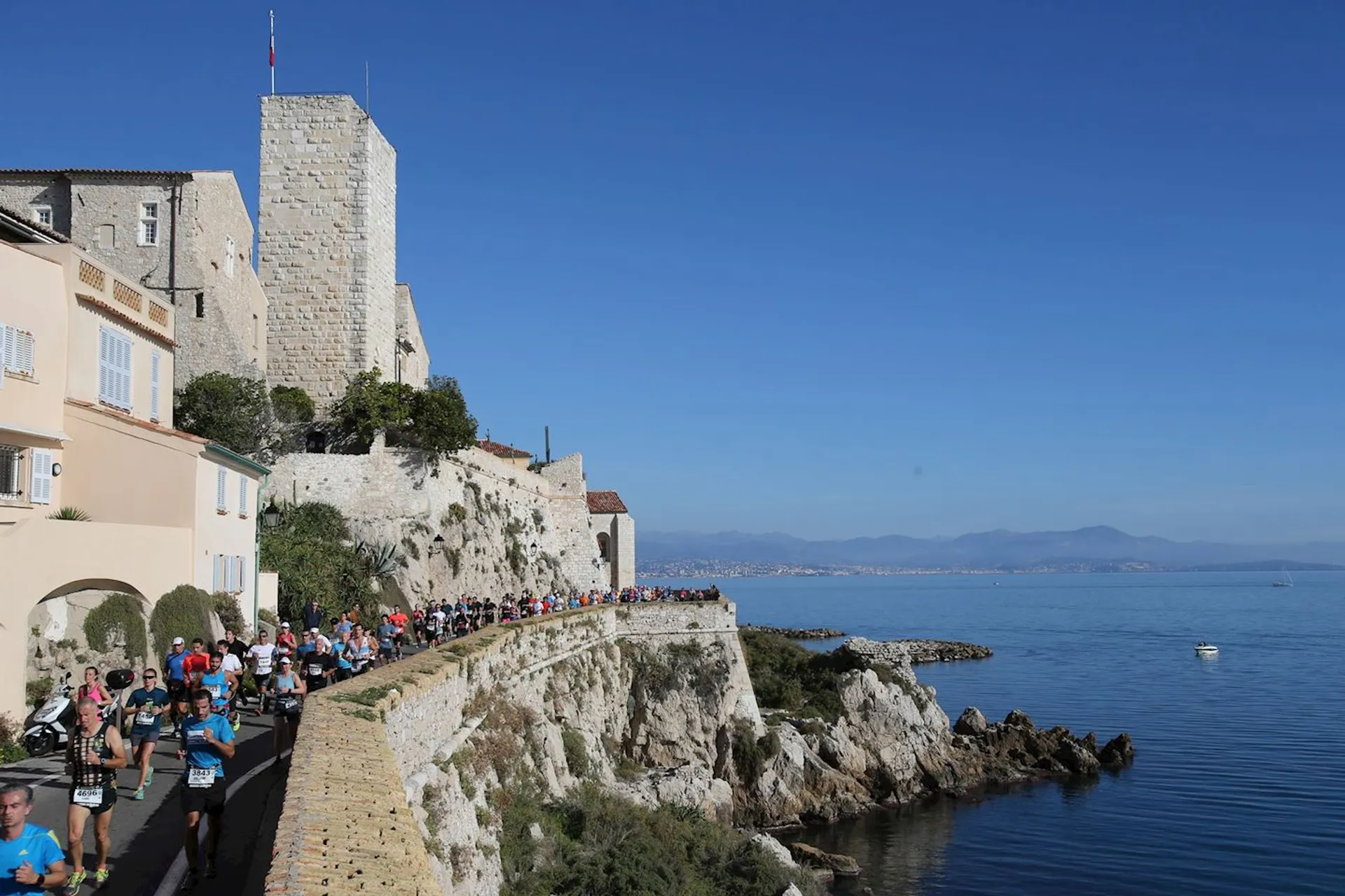 The image shows a group of runners participating in a race or running event along a