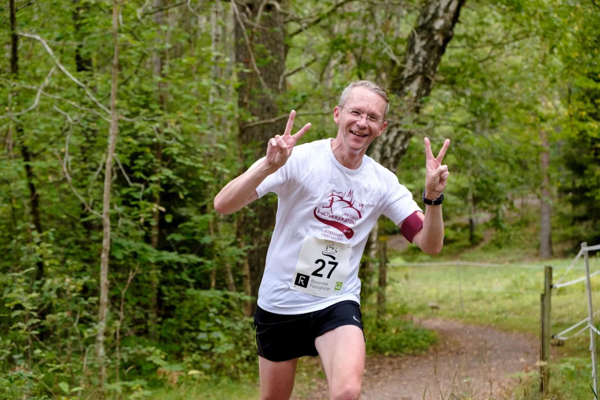 The image shows a person running in what appears to be a trail or cross-country