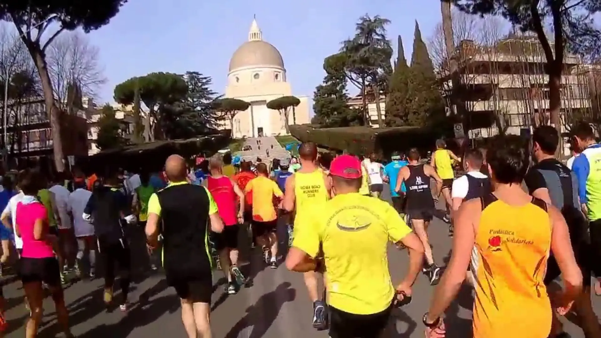 The image shows a group of people participating in a running event. They are wearing