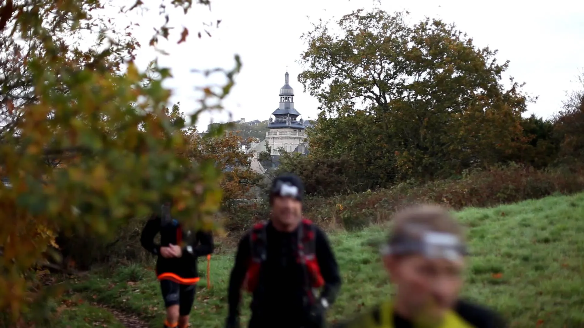 The image shows a group of people in the foreground, likely engaging in an outdoor