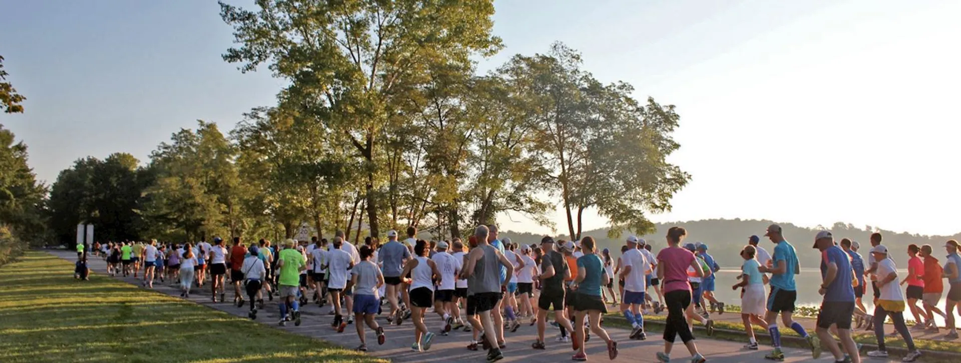 The image shows a group of people participating in a running event. They are running