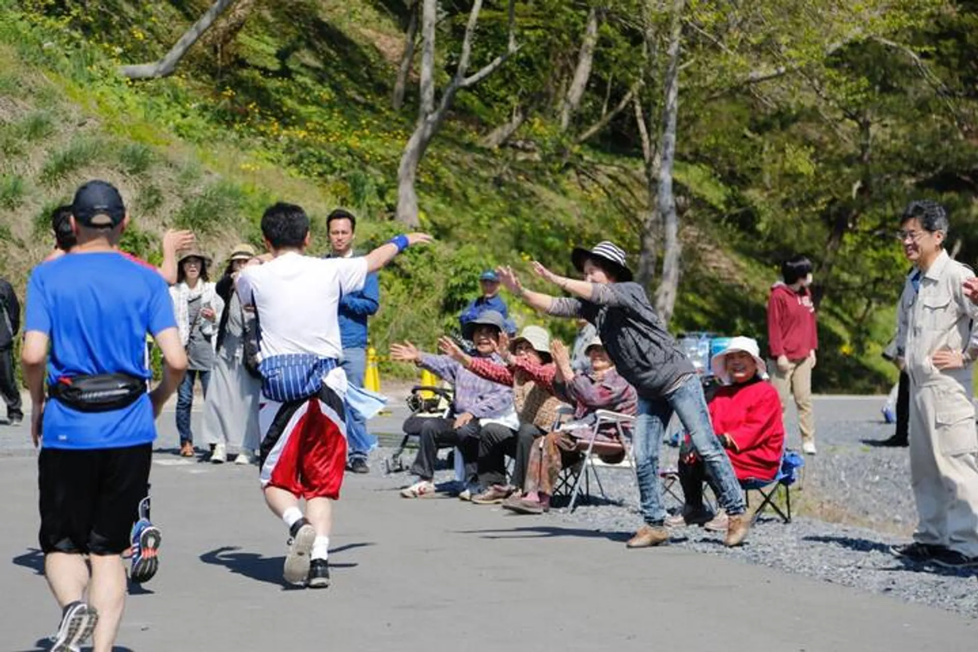 The image depicts an outdoor scene where a group of people is involved in what appears