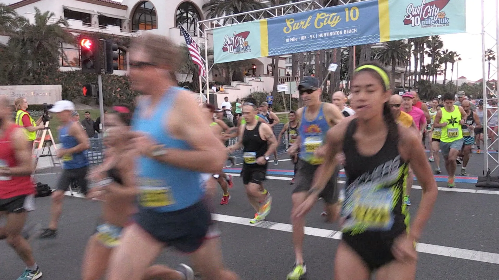 The image shows a group of runners participating in a road race, likely a 