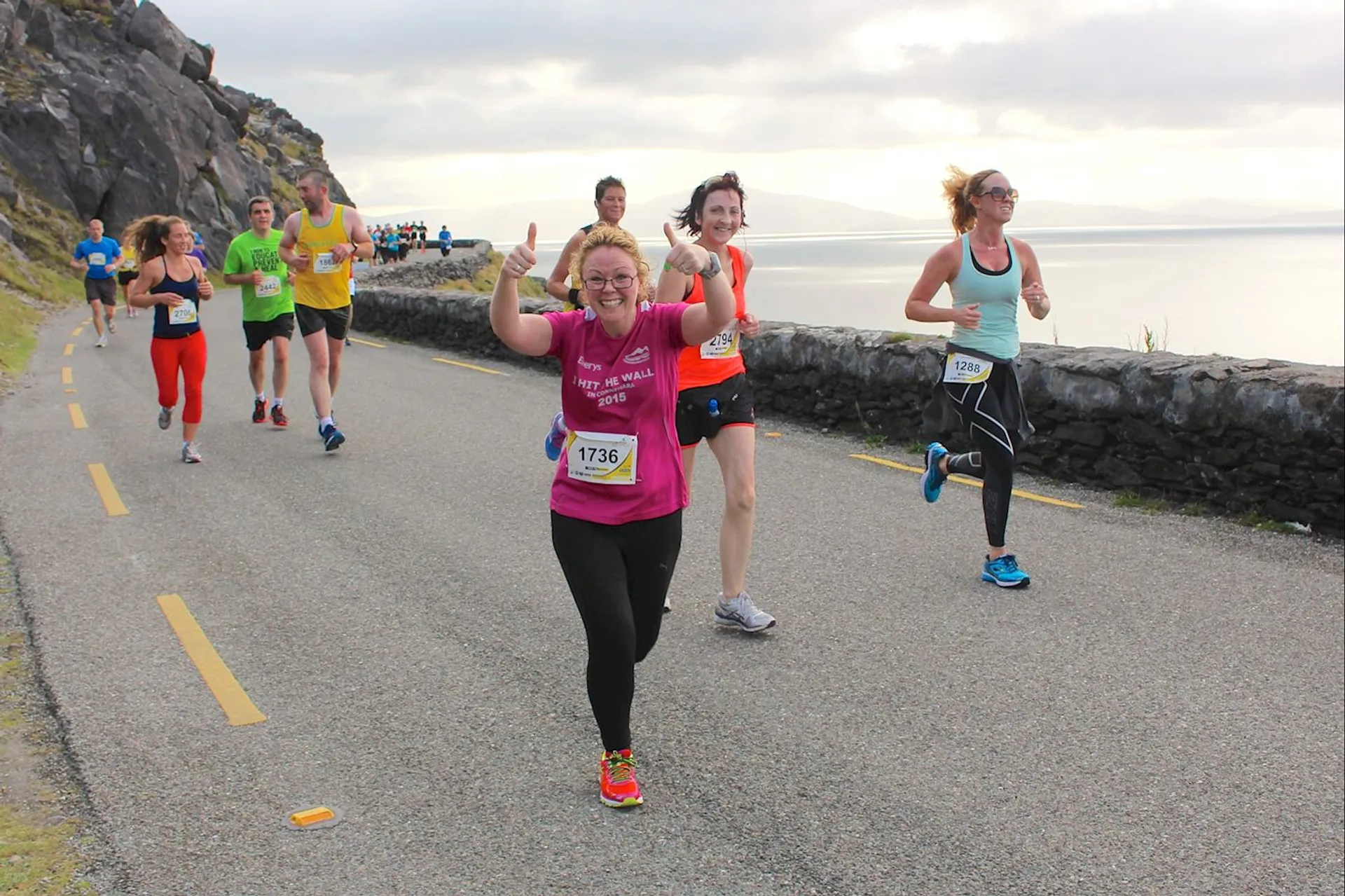 The image shows a group of people participating in a running event, likely a marathon