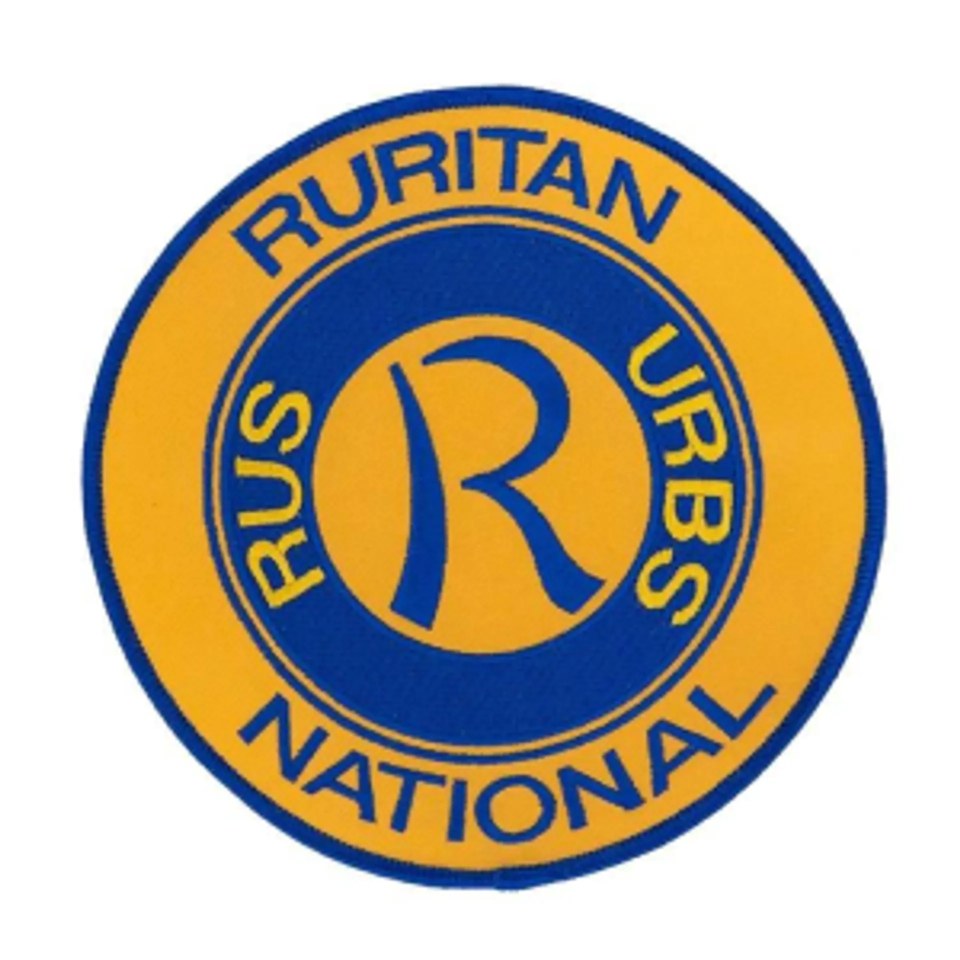 The image contains a circular emblem with a blue and gold color scheme. It has the word "RURITAN" written on the upper half and "NATIONAL" on the lower half, dividing the circle's border. Inside, there is a large gold letter "R" on a blue circular background, and around it, it appears to say "RUS URBS" separated by two small dots. The emblem represents Ruritan National, a service club located in the United States that focuses on improving communities and fostering fellowship.