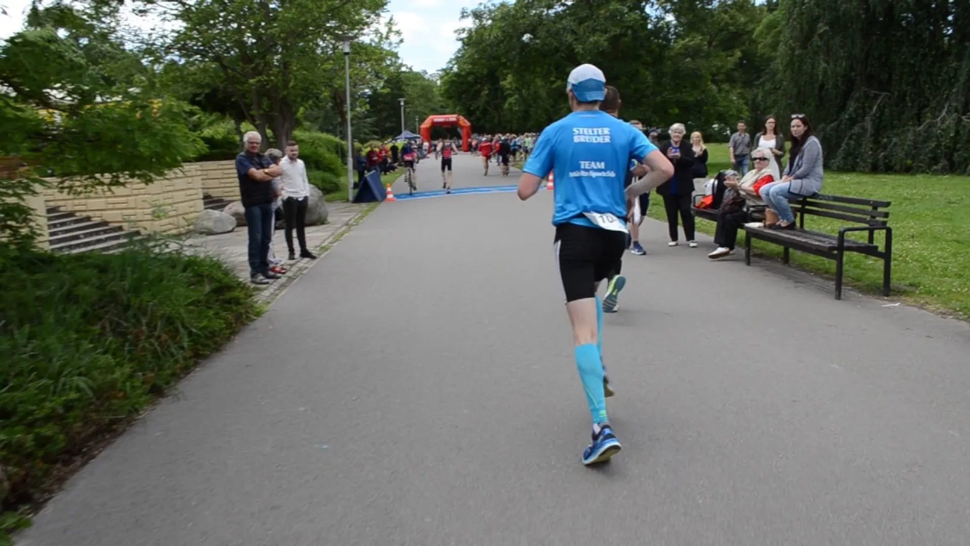 In the image, there is a person running, dressed in athletic wear with the