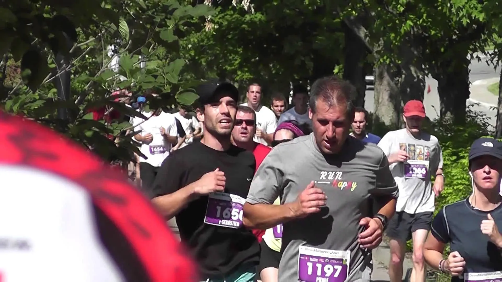 The image shows a group of people participating in a running event. In the foreground