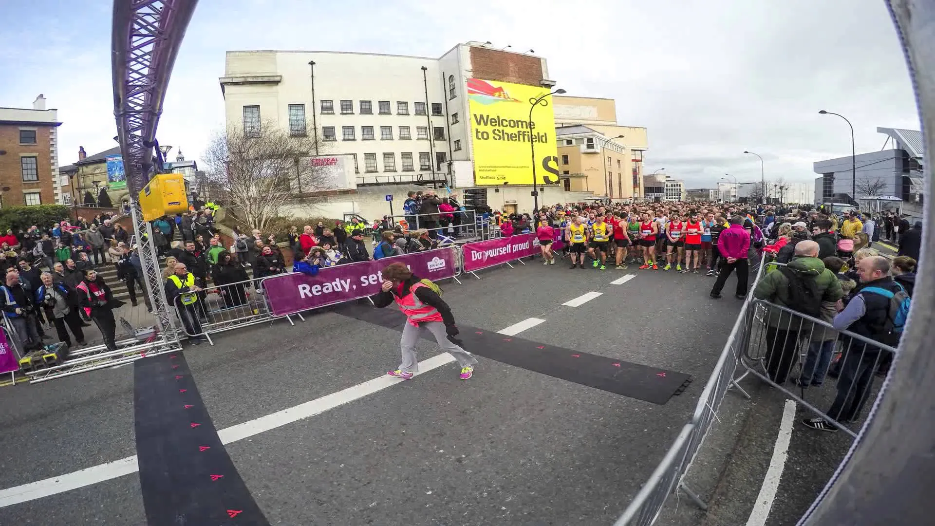The image shows a street scene where a running event is about to take place or