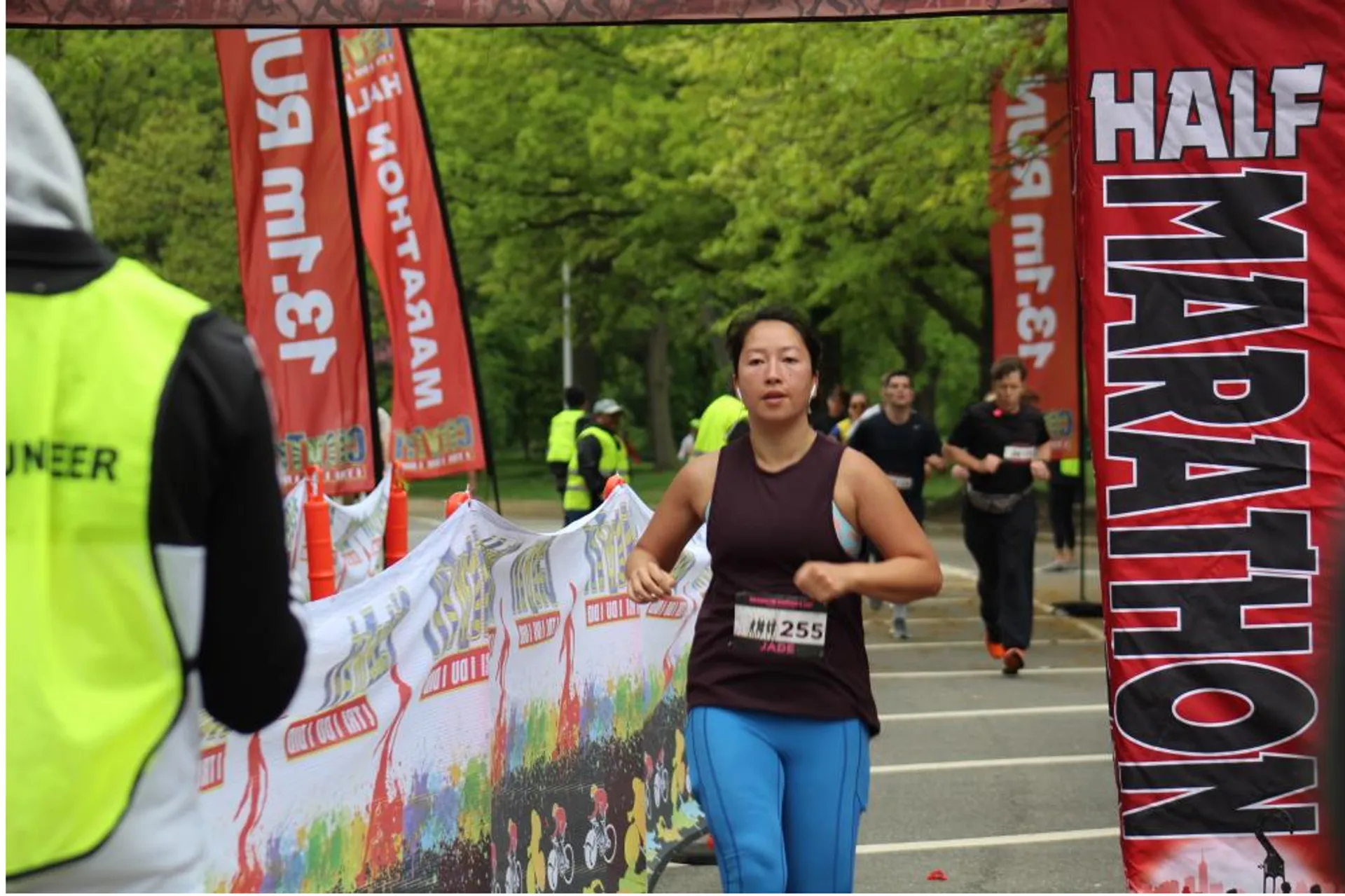 This image shows a running event, likely a half marathon based on the red banner