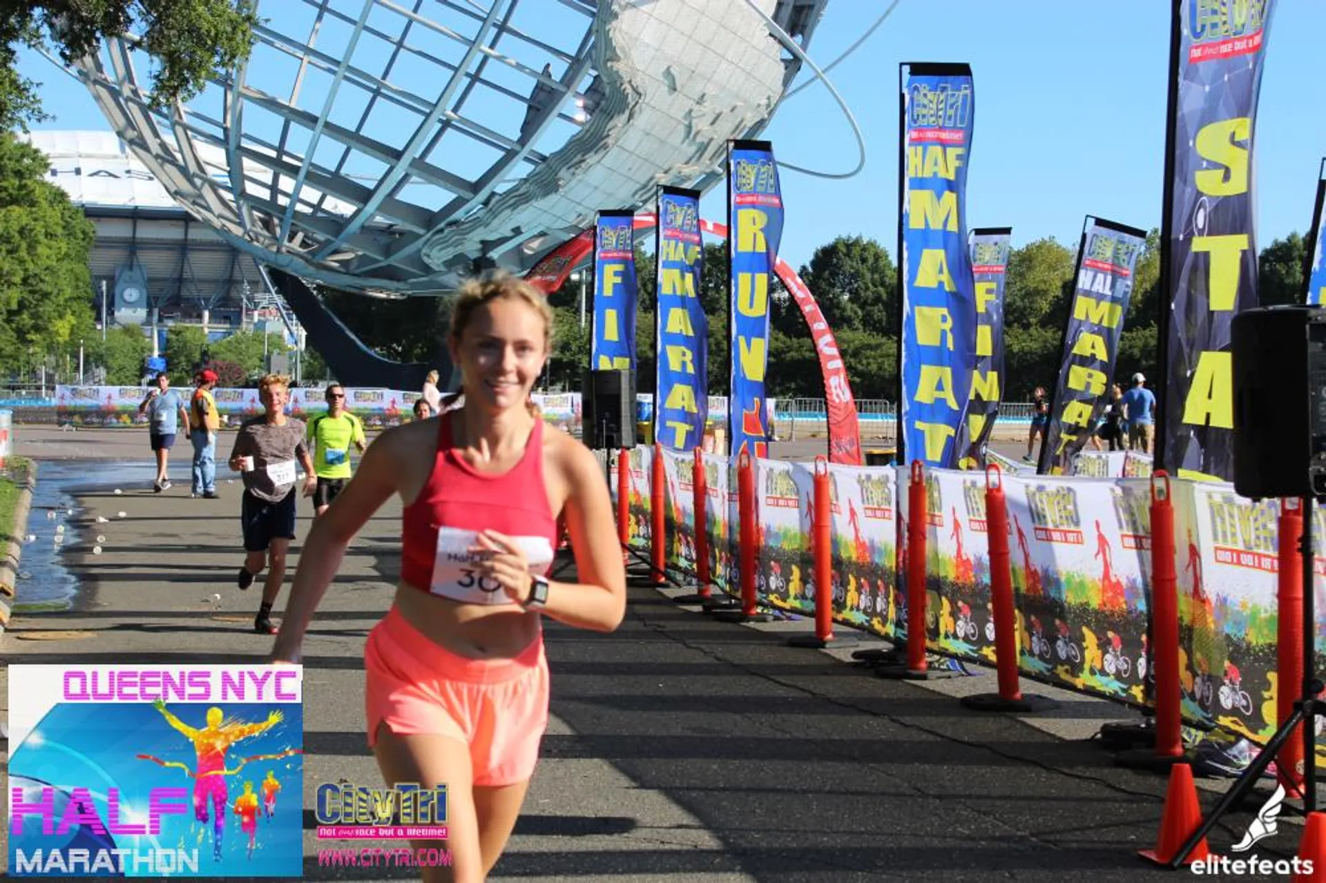 The image shows a female runner who has just finished a race, as indicated by
