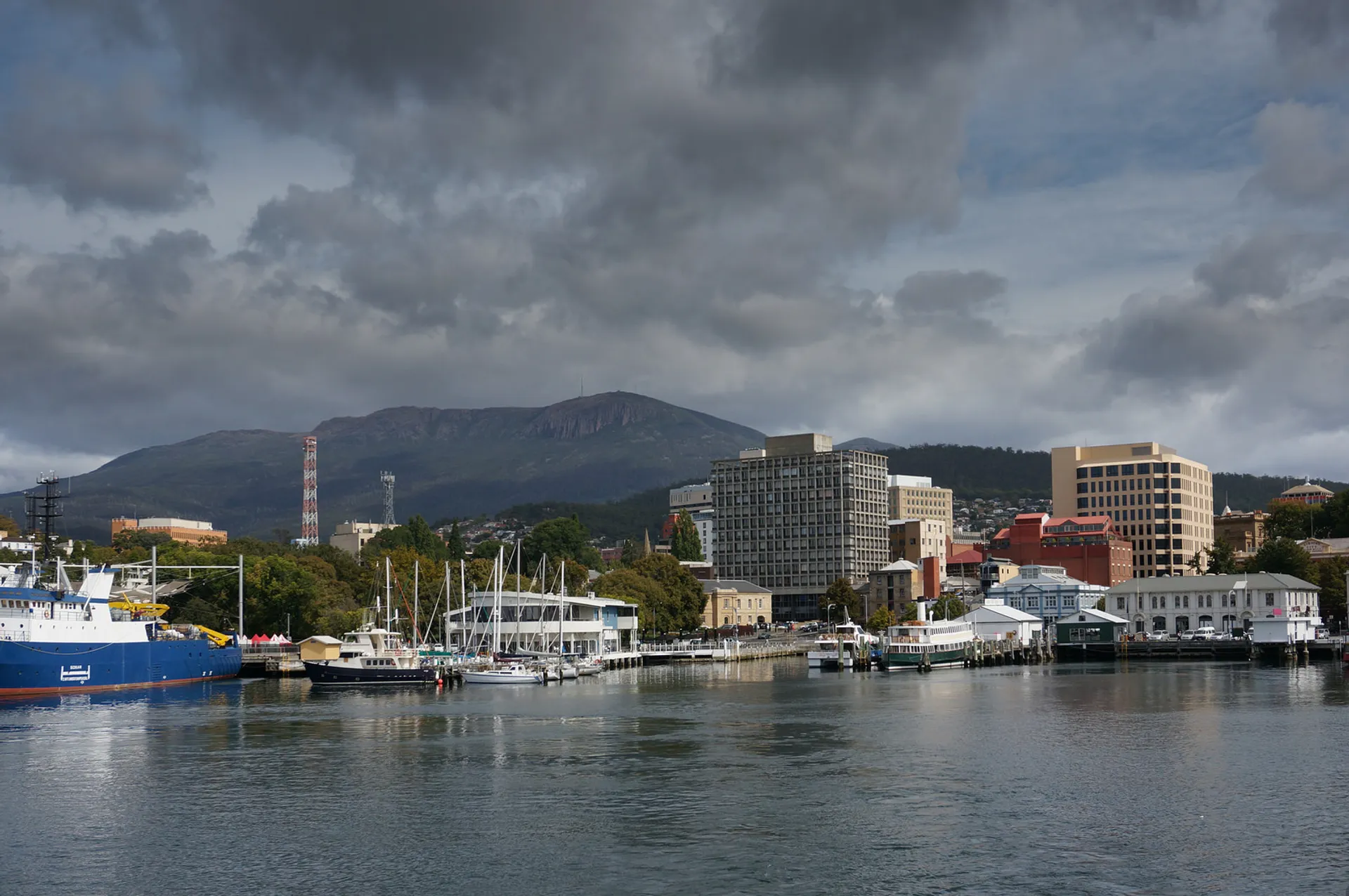 The image shows a waterfront scene with a variety of elements:

1. There are