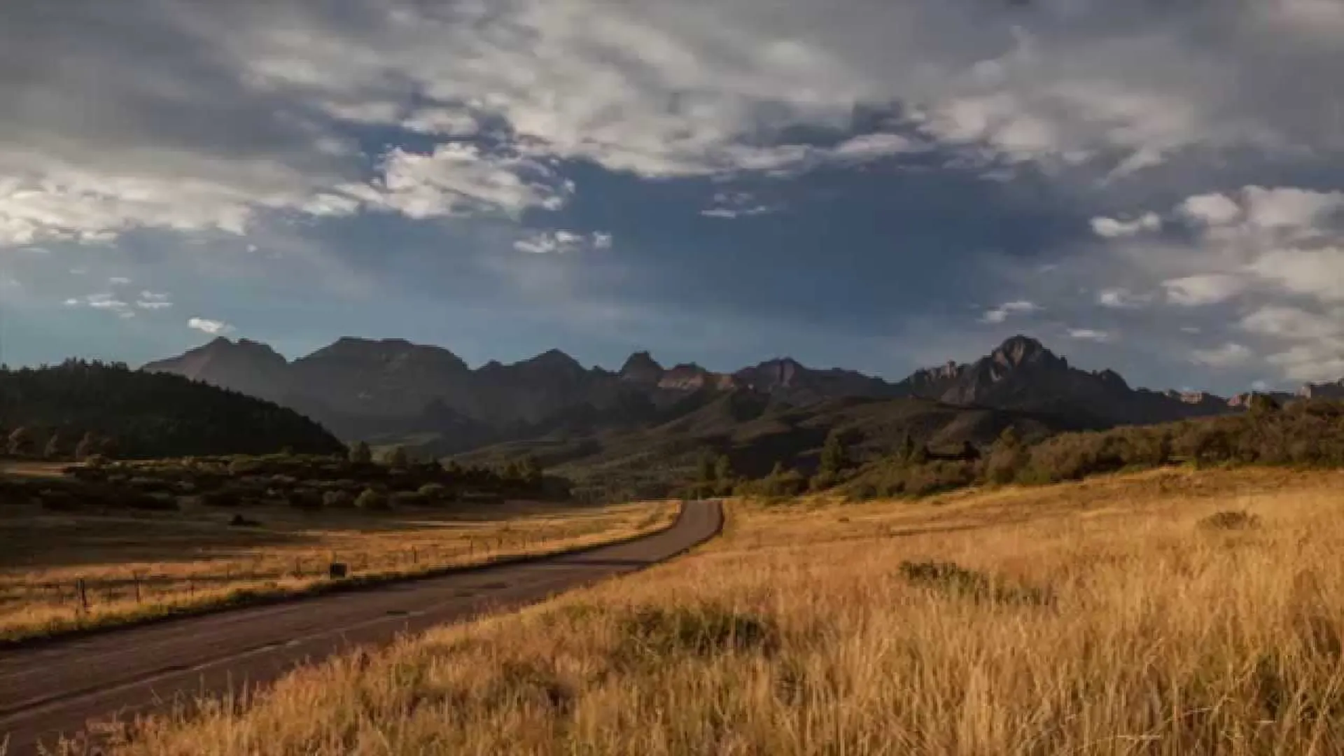 The image you've provided showcases a beautiful natural landscape. There's a dirt road