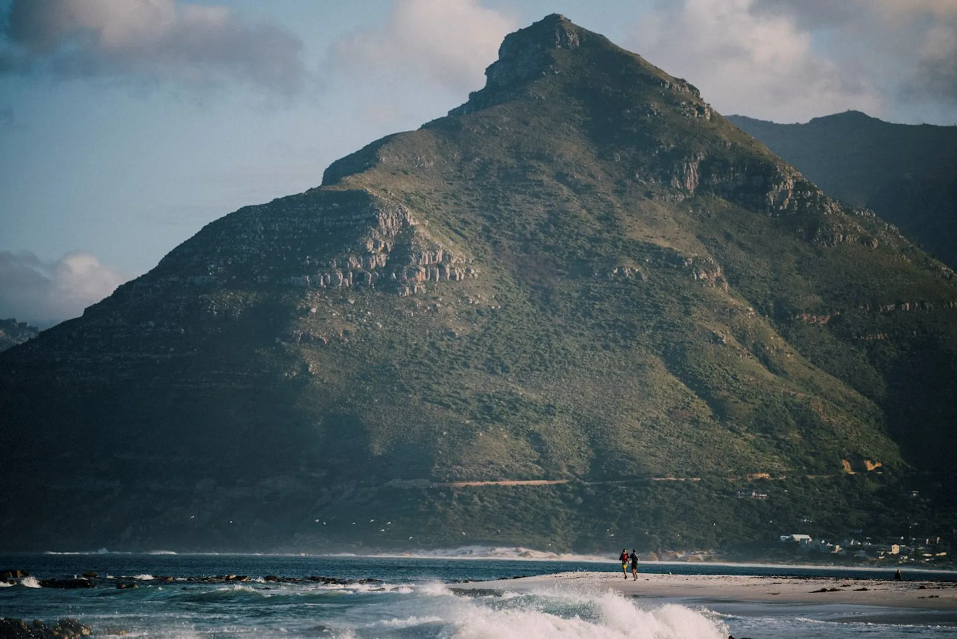 The image depicts a picturesque scene of a beach with waves lapping at the shore