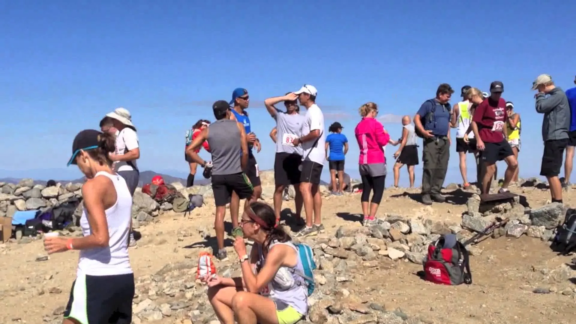 The image shows a group of people outdoors, likely on a hiking or outdoor adventure