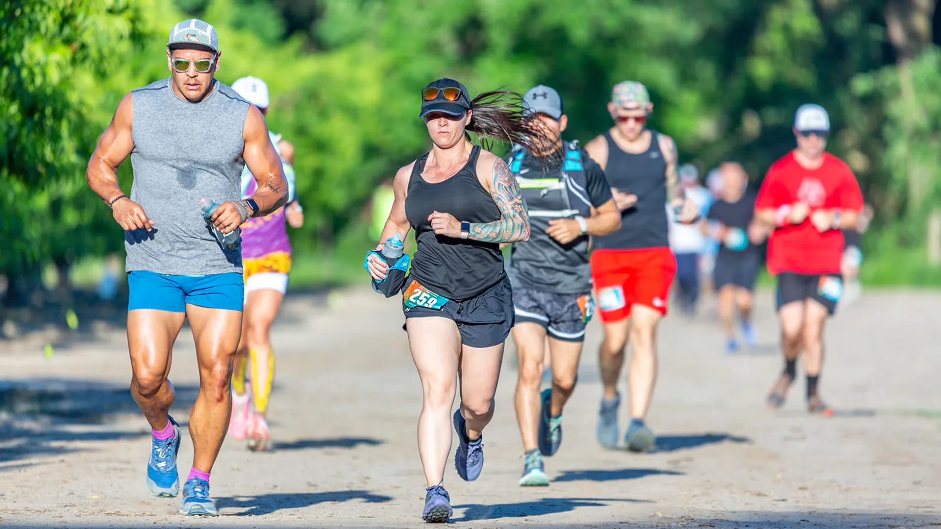 The image shows a group of people engaged in a running event. They appear focused