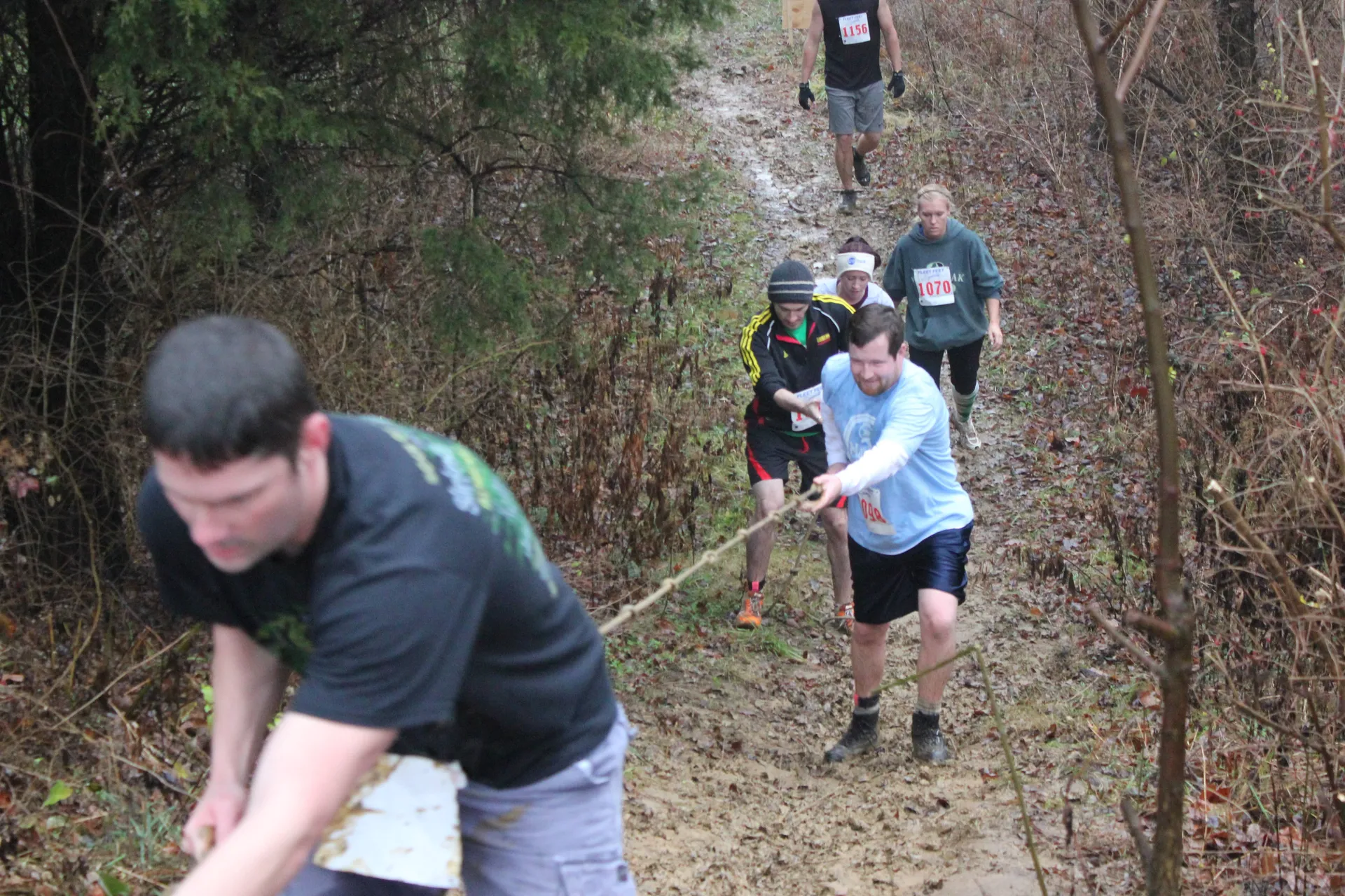The image shows a group of individuals participating in what appears to be an outdoor event