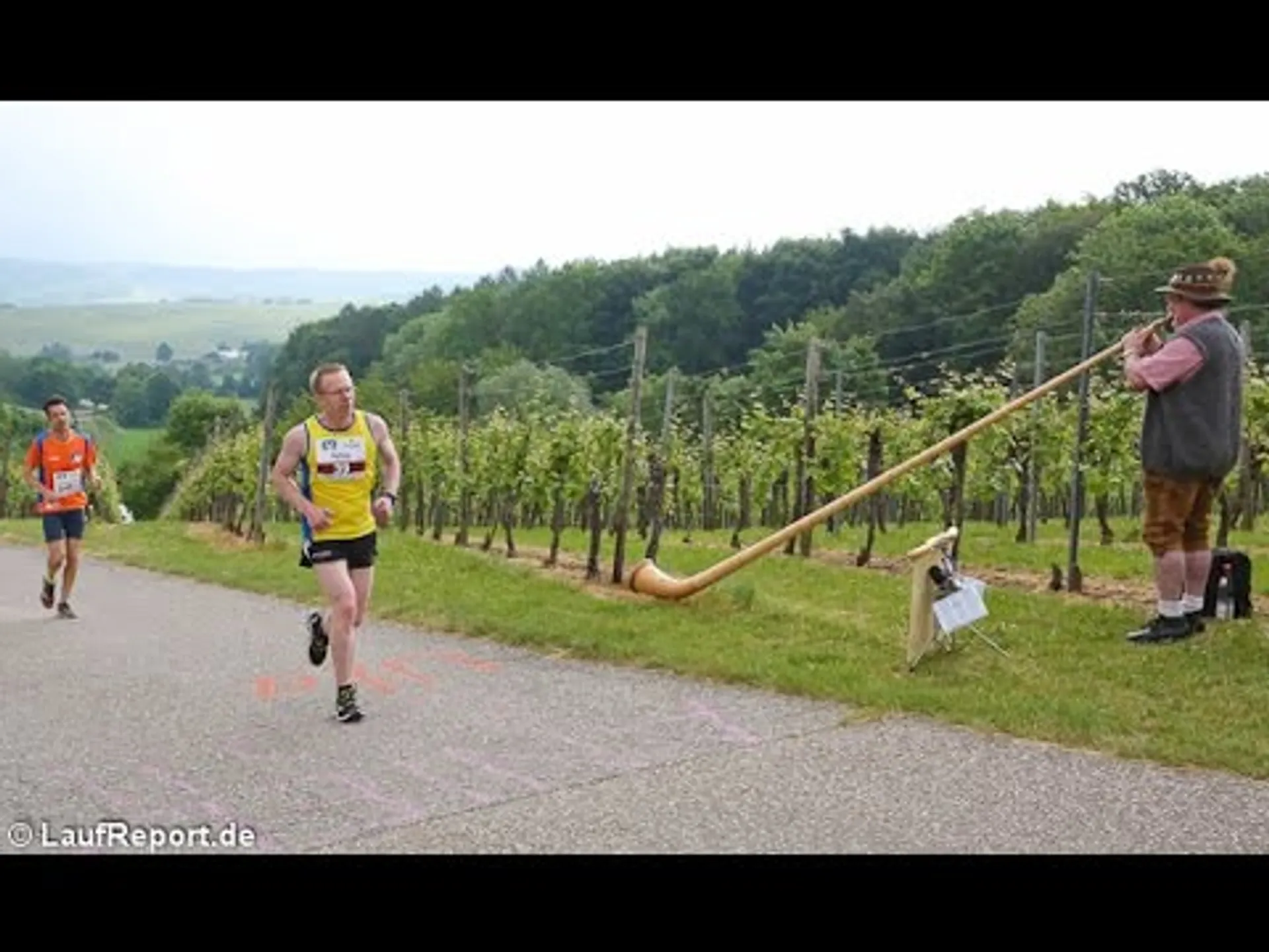 The image shows an outdoor scene where a running event is taking place. In the