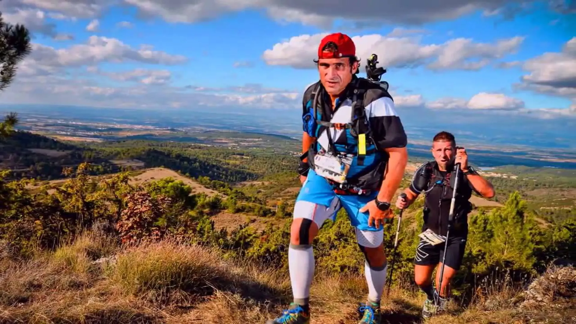The image depicts two individuals engaged in outdoor activities, likely hiking or trail running,