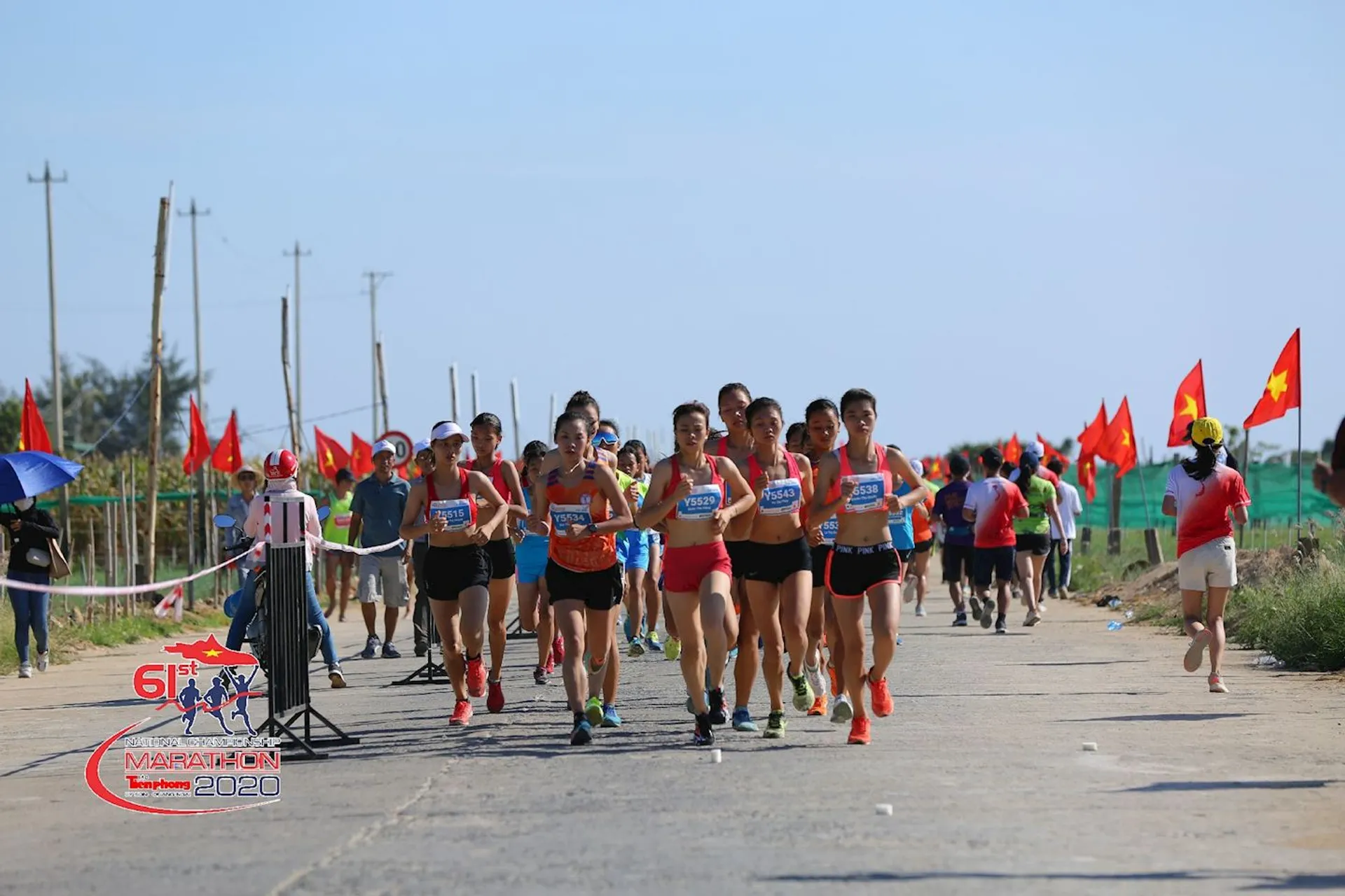 The image shows a group of runners participating in a marathon event. They are running