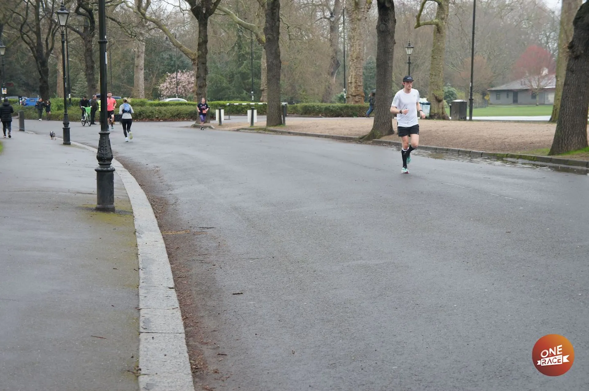 This image shows a park setting where several individuals are engaged in outdoor activities, predominantly