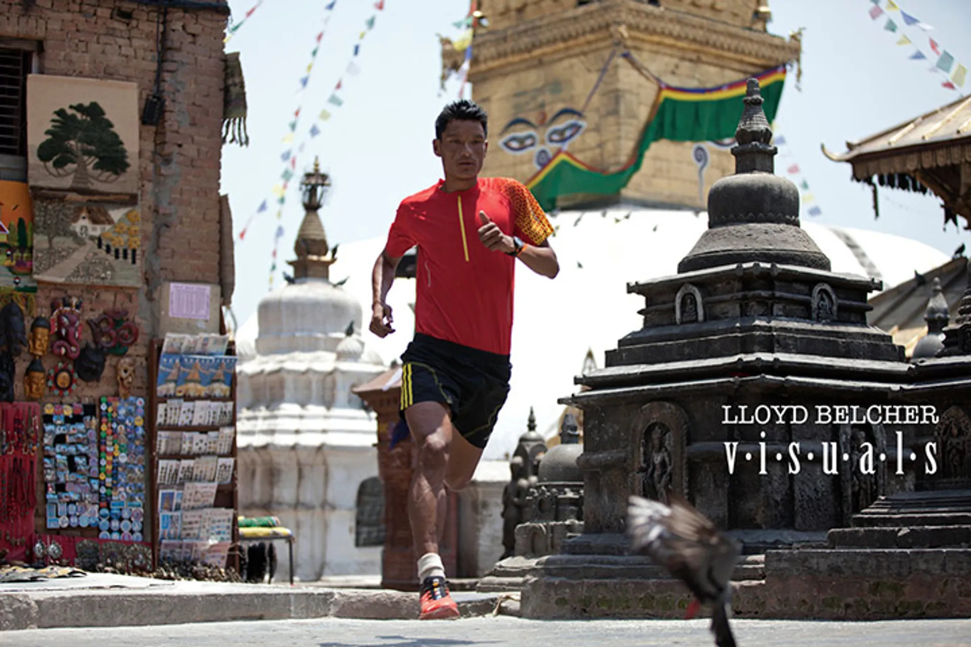 The image shows a person jogging past some small stupas or shrines in an