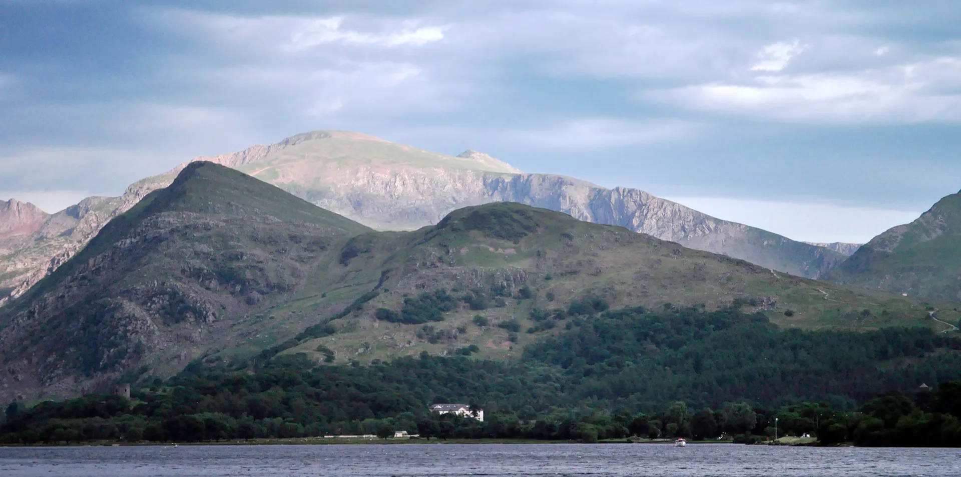 The image shows a beautiful landscape featuring a large body of water in the foreground,