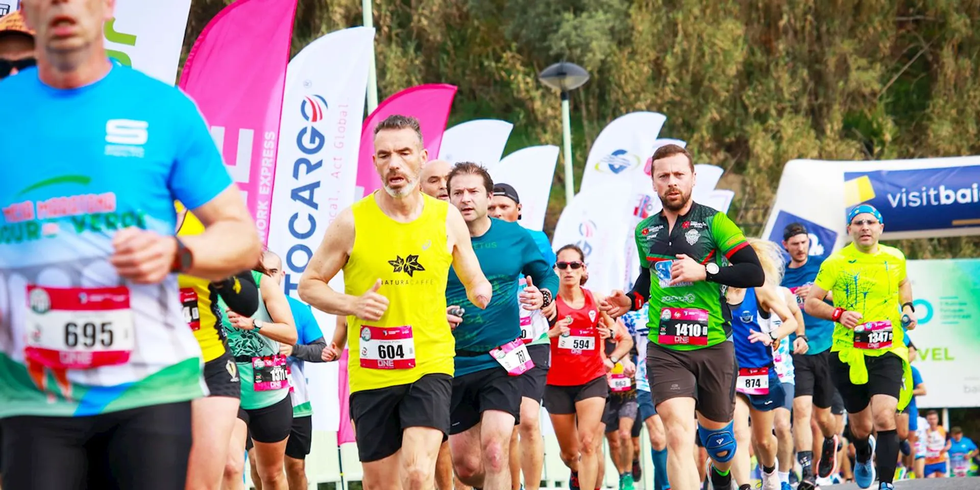 The image shows a group of runners participating in a race. They are wearing athletic
