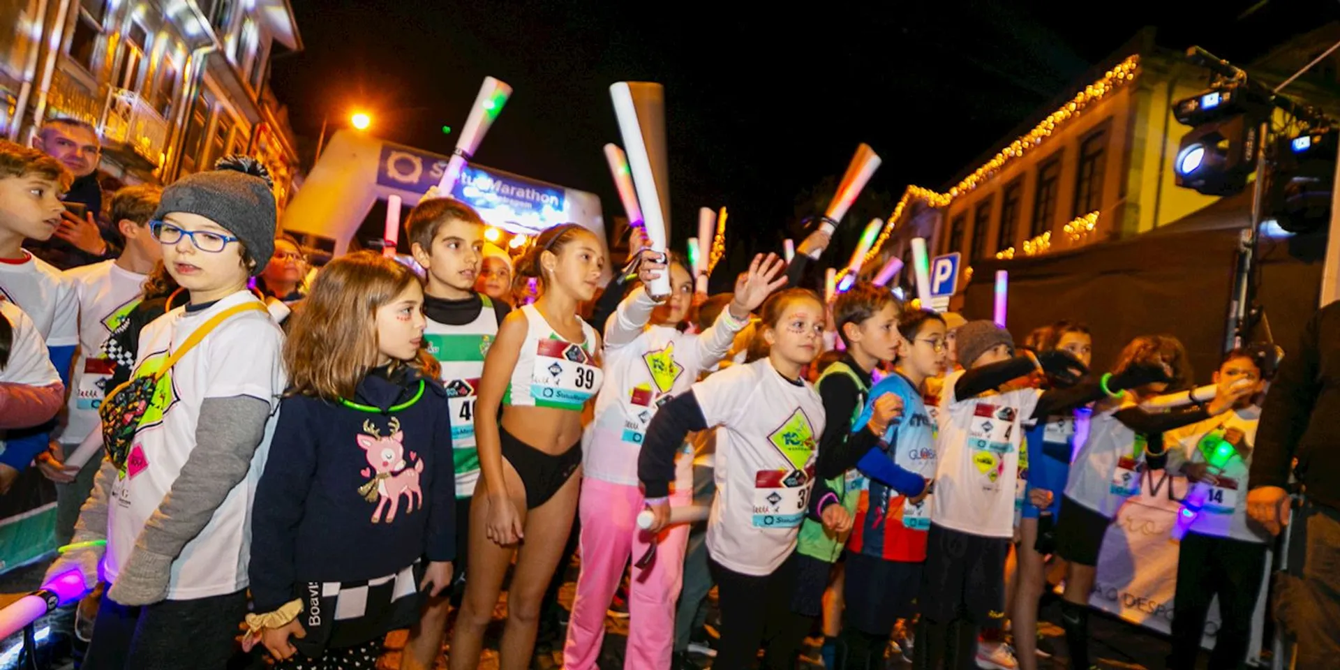 The image shows a group of children at what appears to be an outdoor night event
