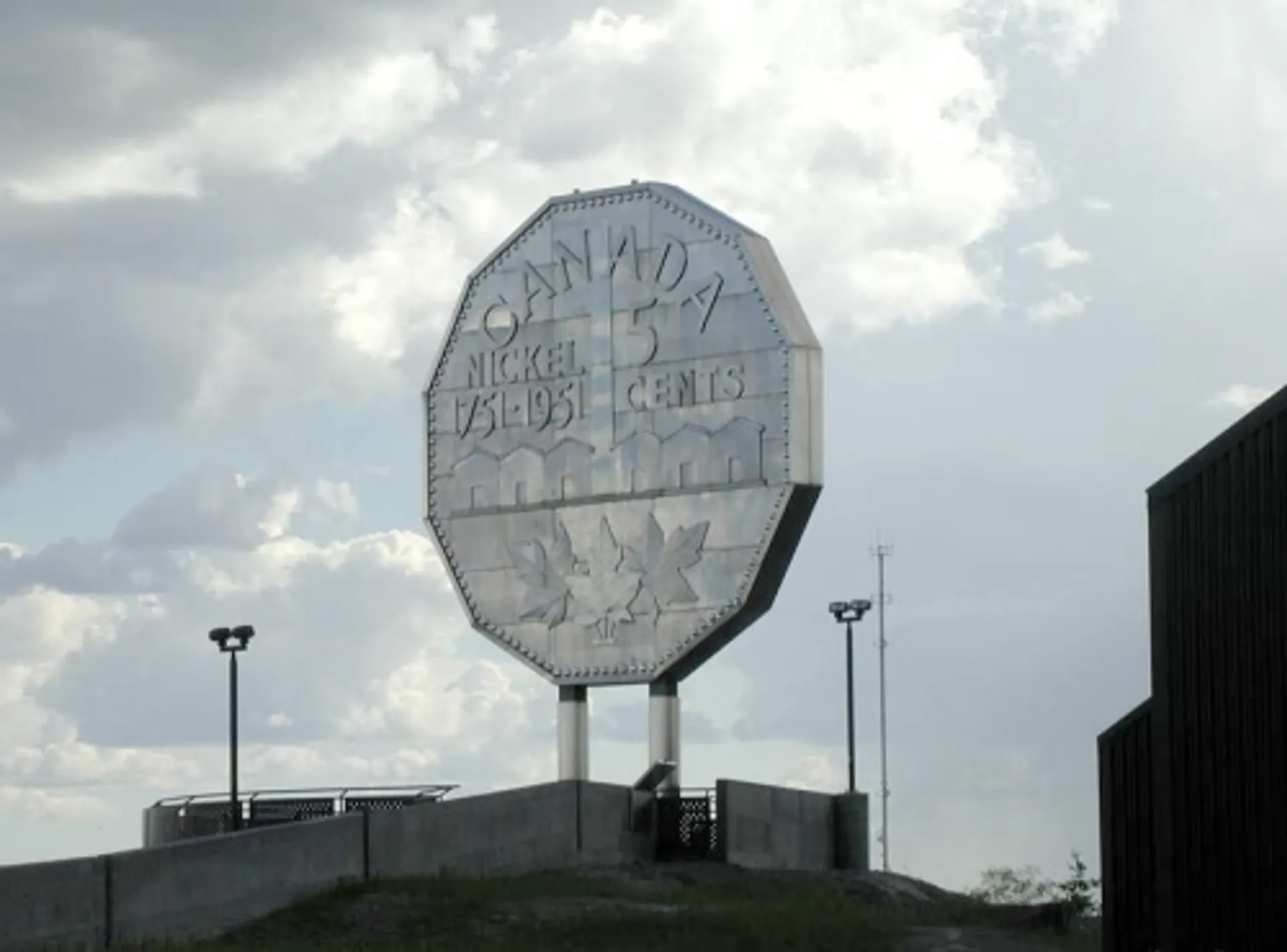 The image shows the Big Nickel, a large replica of a Canadian five-cent coin
